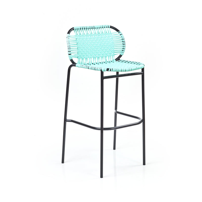The Ames Cielo Barstool by Ames features a tall black metal frame with a turquoise woven seat and backrest, inspired by Sebastian Herkner, set against a plain white background.