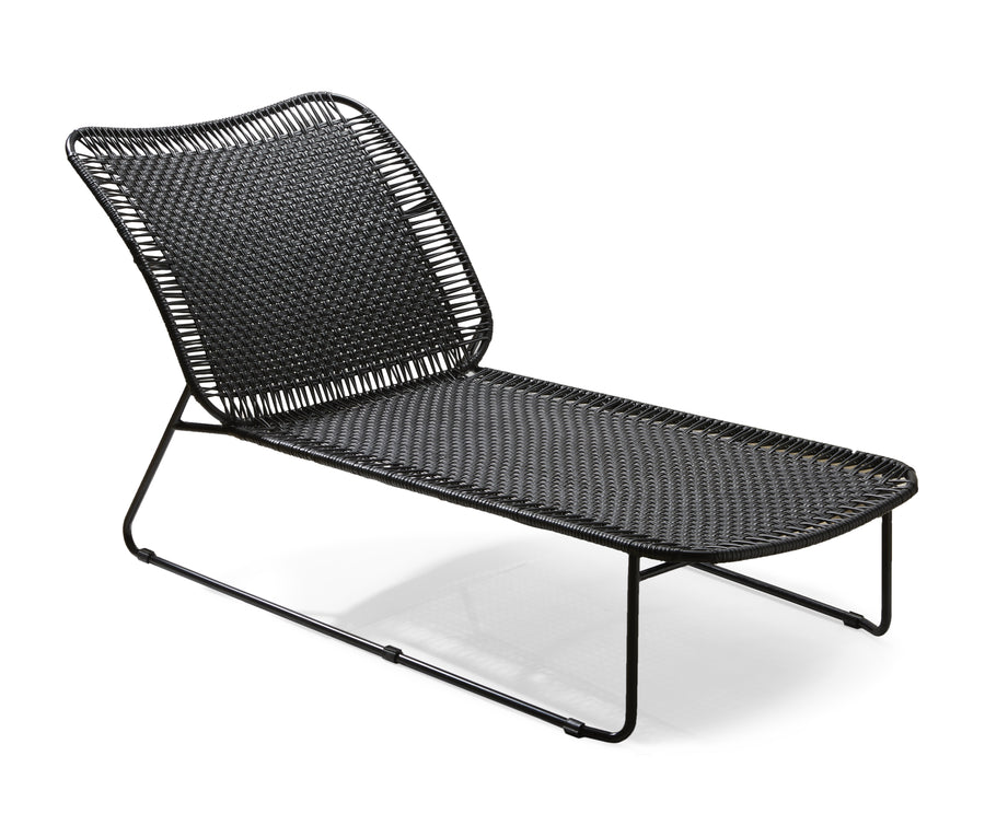 The Ames Cielo Daybed by Ames is a modern black woven chaise lounge with a metal frame and curved seat, perfect for stylish relaxation indoors or outdoors.