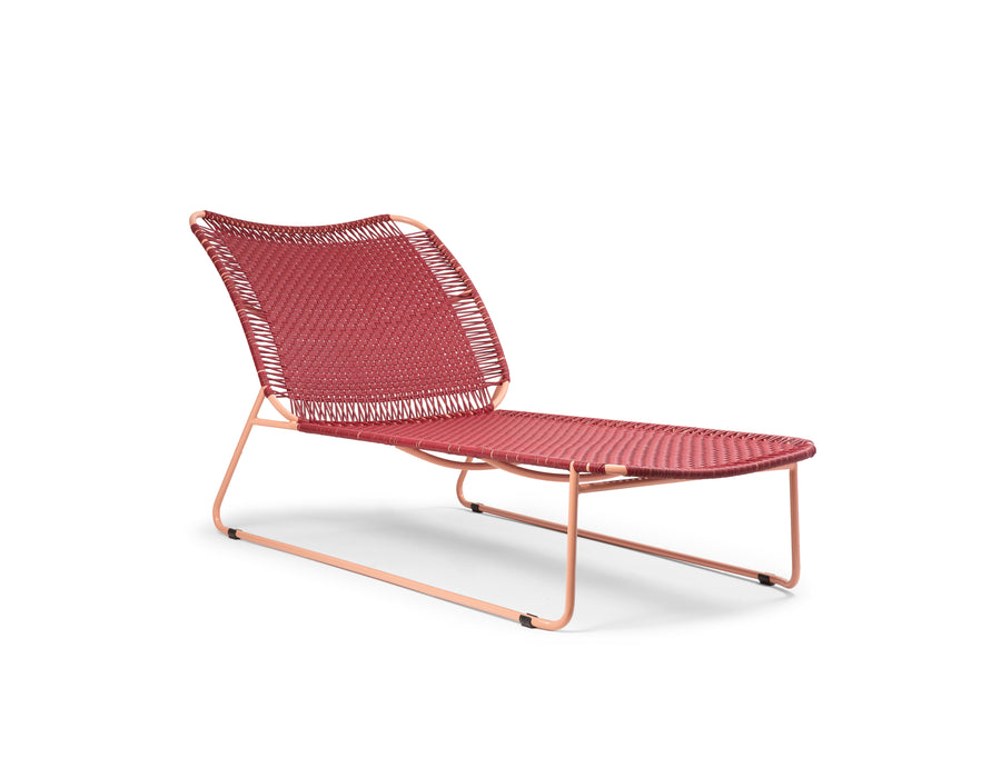 The Ames Cielo Daybed by Ames is a modern red woven chaise lounge with a metal frame, angled legs, and curved backrest and seat, perfect for stylish indoor or outdoor relaxation.