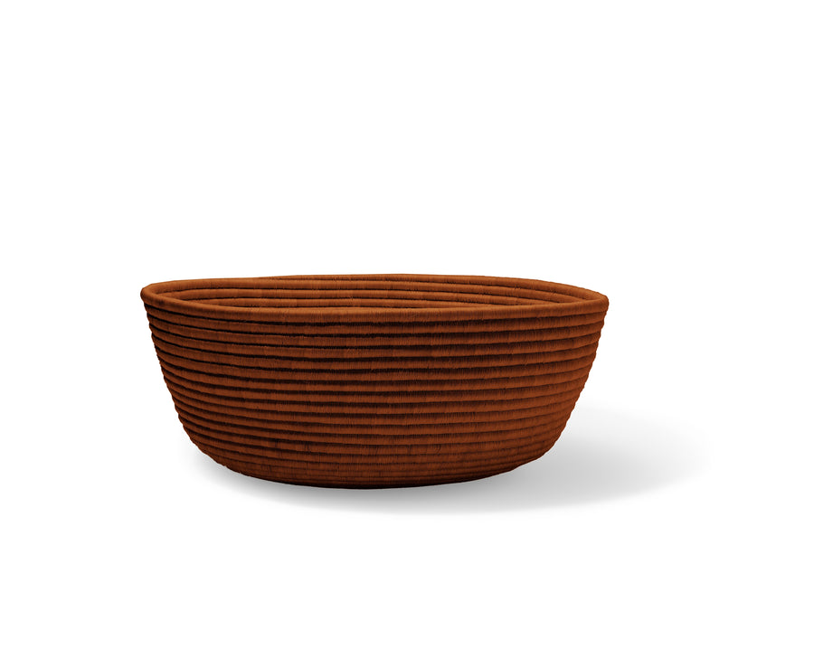 The Ames La Che basket by Ames features a round, rust-colored fabric design with a ribbed, corduroy-like texture, evoking the look of handcrafted baskets—shown here against a plain white background.