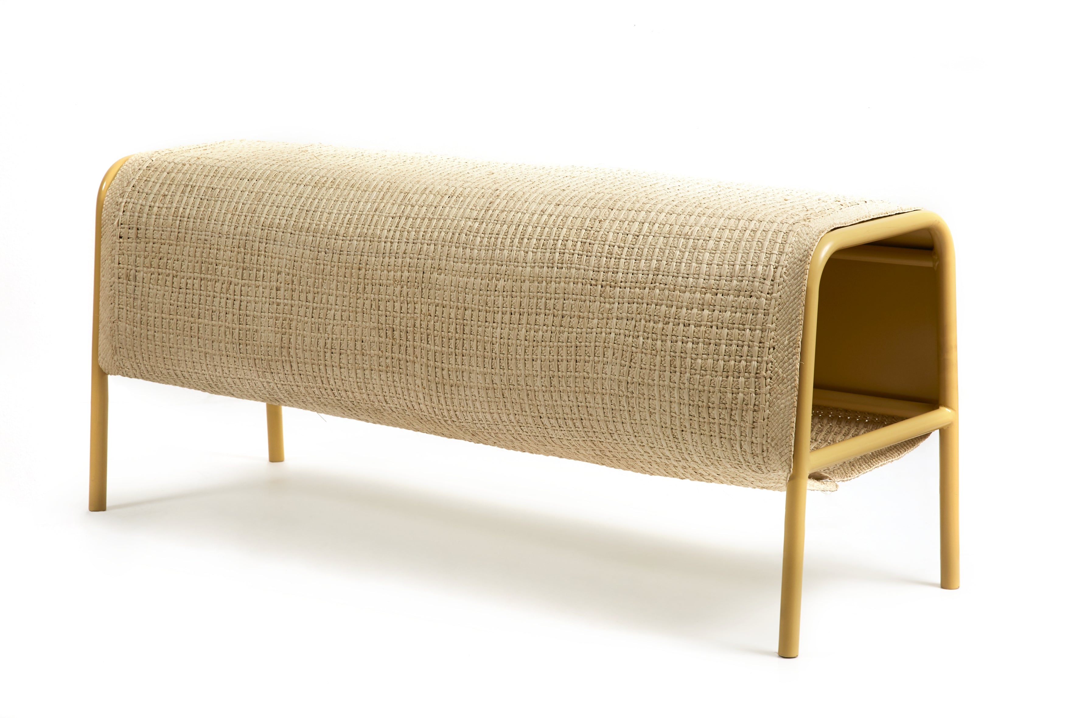 The Ames Mecato Bench by Ames features a yellow powder-coated steel frame and a beige woven iraca palm seat, shown on a white background. This bench offers a minimalist, contemporary design.