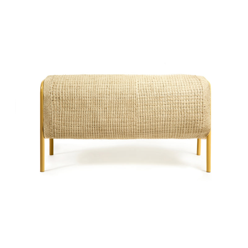 The Ames Mecato Bench by Ames features a woven iraca palm seat and yellow powder-coated steel legs, shown against a white background.