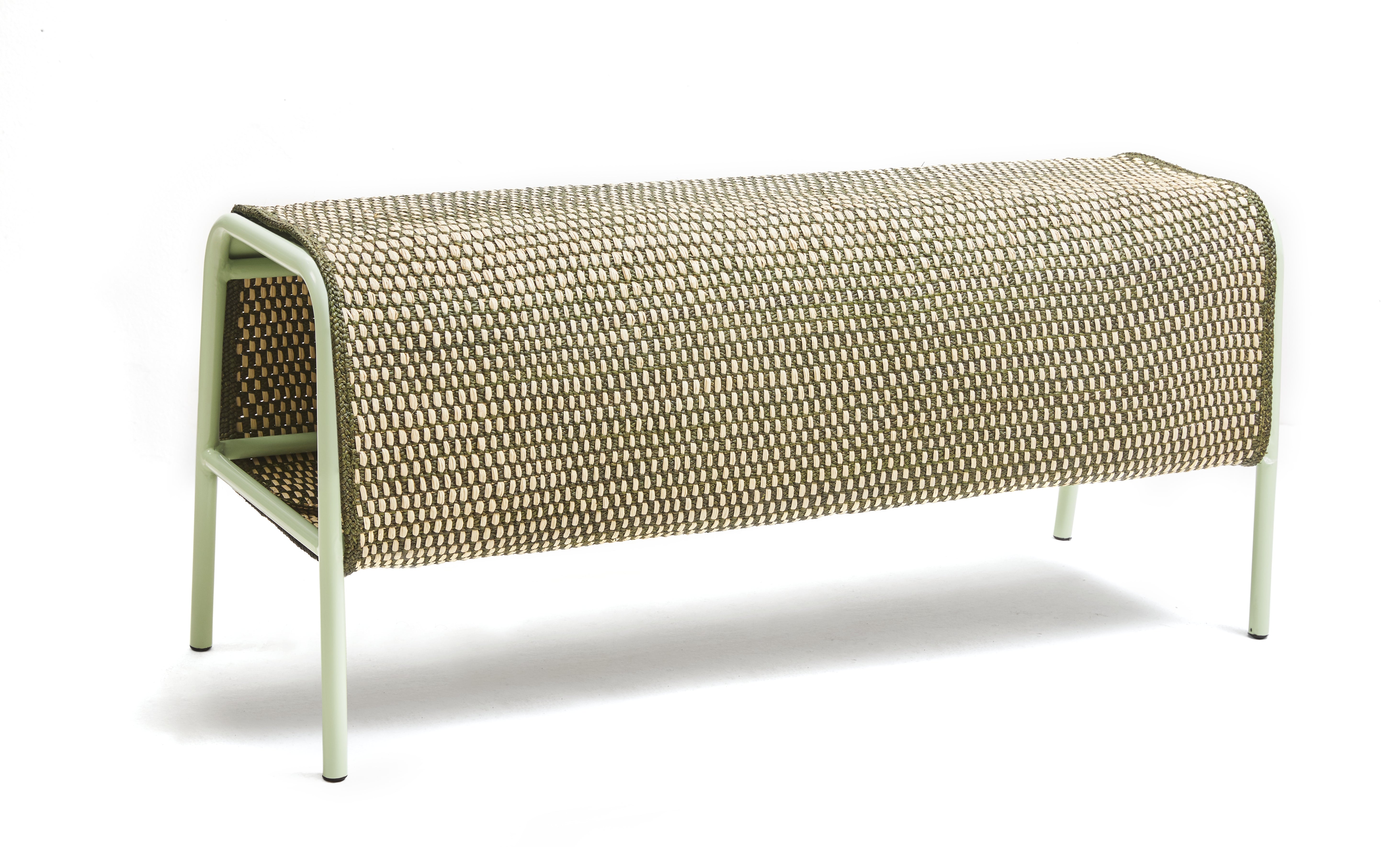 The Ames Mecato Bench by Ames features a rectangular iraca palm woven seat with rounded edges and four light-colored, powder-coated steel legs, shown against a white background.