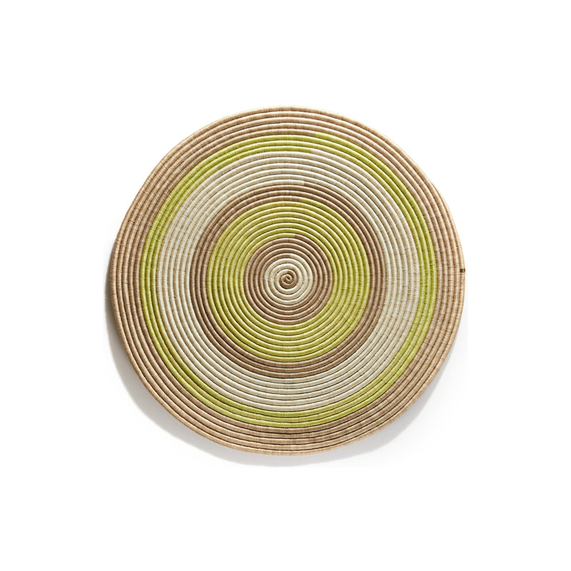 The Ames Ojitos Wall Decoration Andes by Ames is a round, woven basket made from fique palm fibers, featuring beige, brown, and light green concentric circles—perfect for adding unique style to your wall decor.