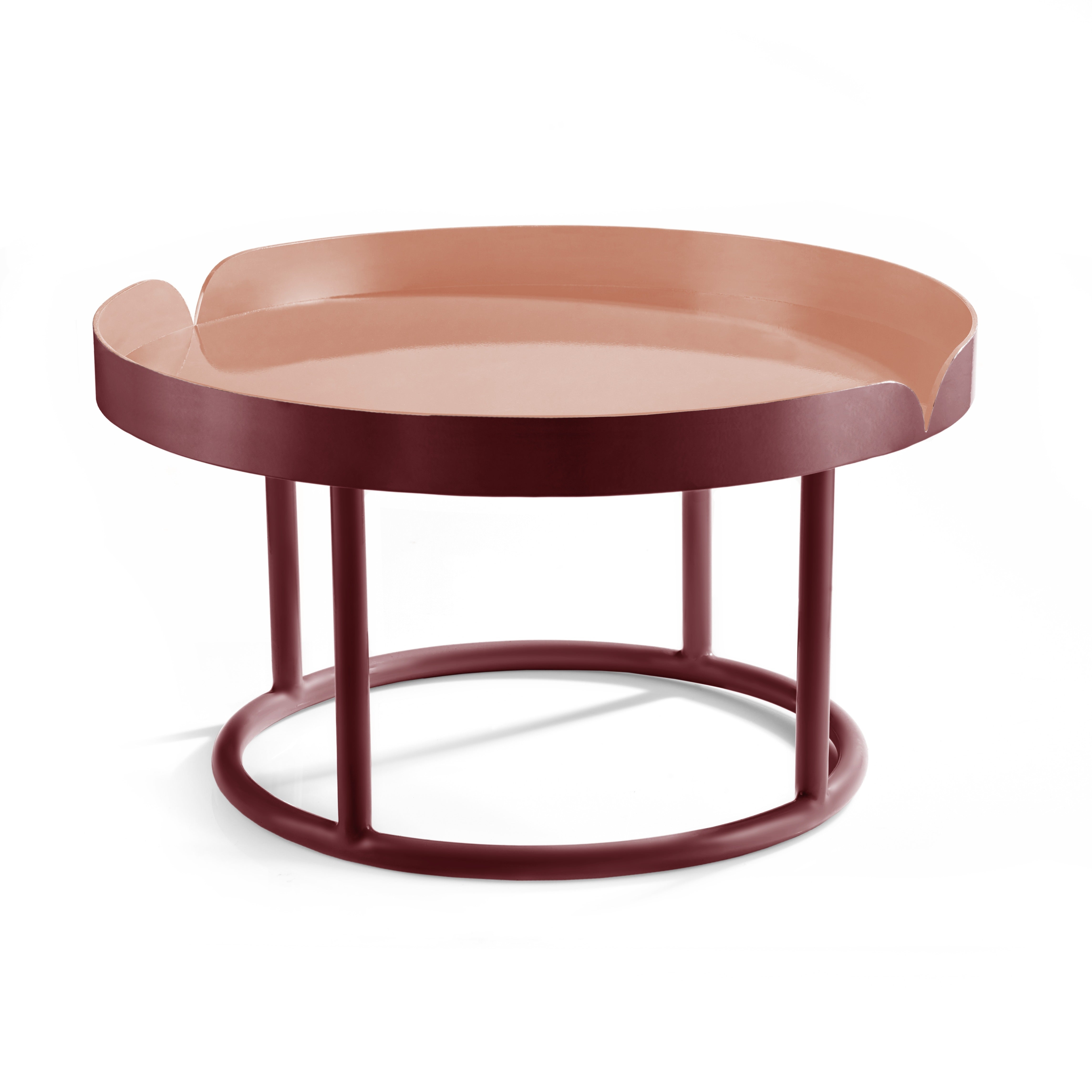 The Ames Victorias Coffee Table 1 by Ames is a round, modern piece with a pink tray-like top and maroon base on four vertical legs, inspired by Cristina Celestino.