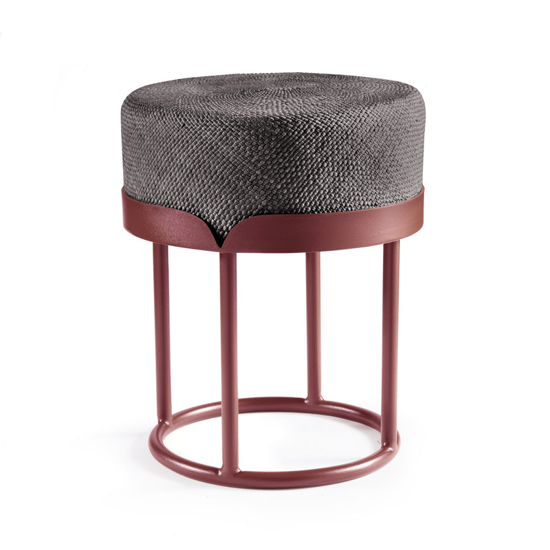 The Ames Victorias Pouf by Ames features a round, textured gray cushion on a pink metal base with four vertical legs and circular supports. Its modern, minimalist design reflects the refined aesthetic of Amazonia furniture.