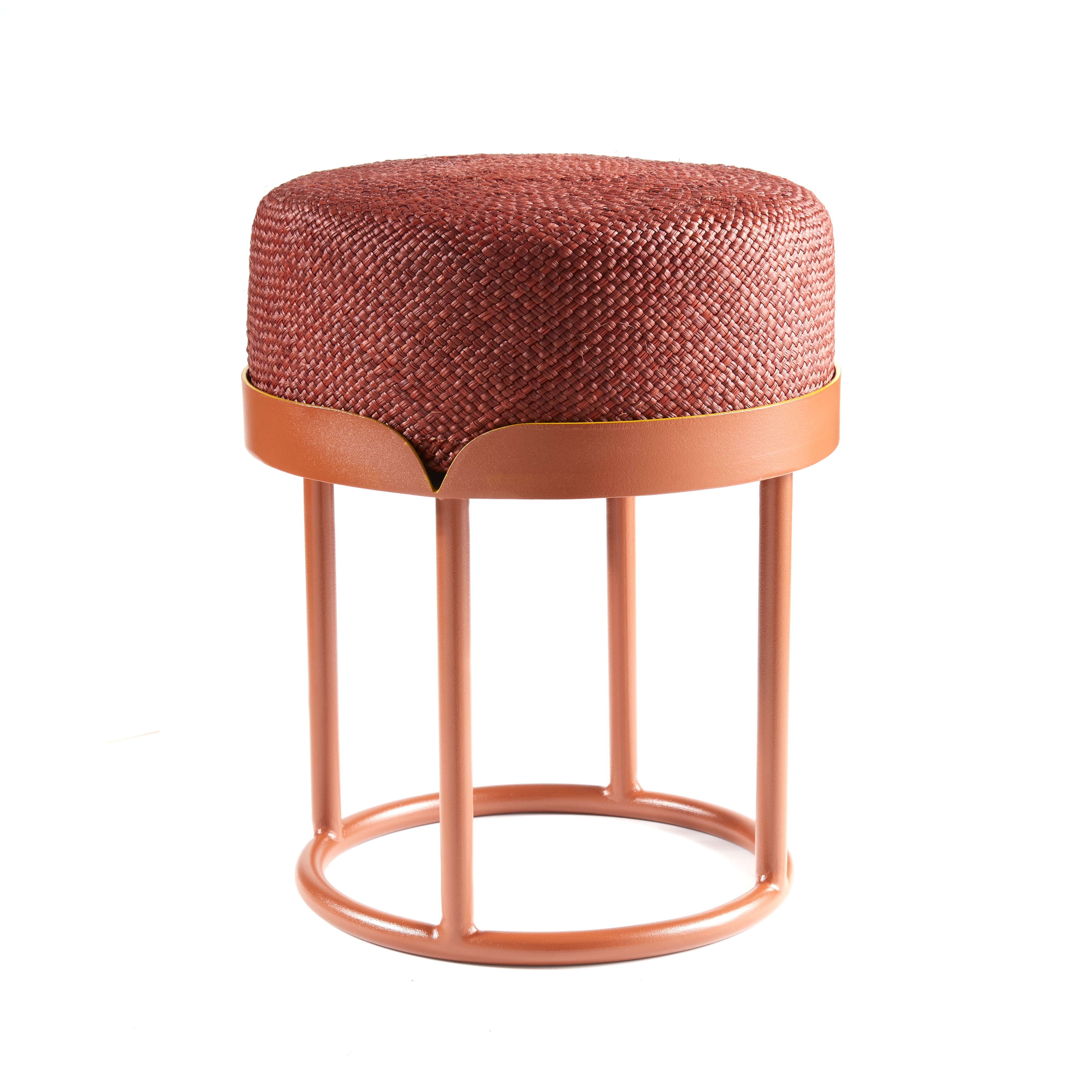 The Ames Victorias Pouf by Ames is a modern stool inspired by Cristina Celestino, with a woven reddish-brown cushion and a round peach-colored metal frame featuring four vertical supports and a circular base.