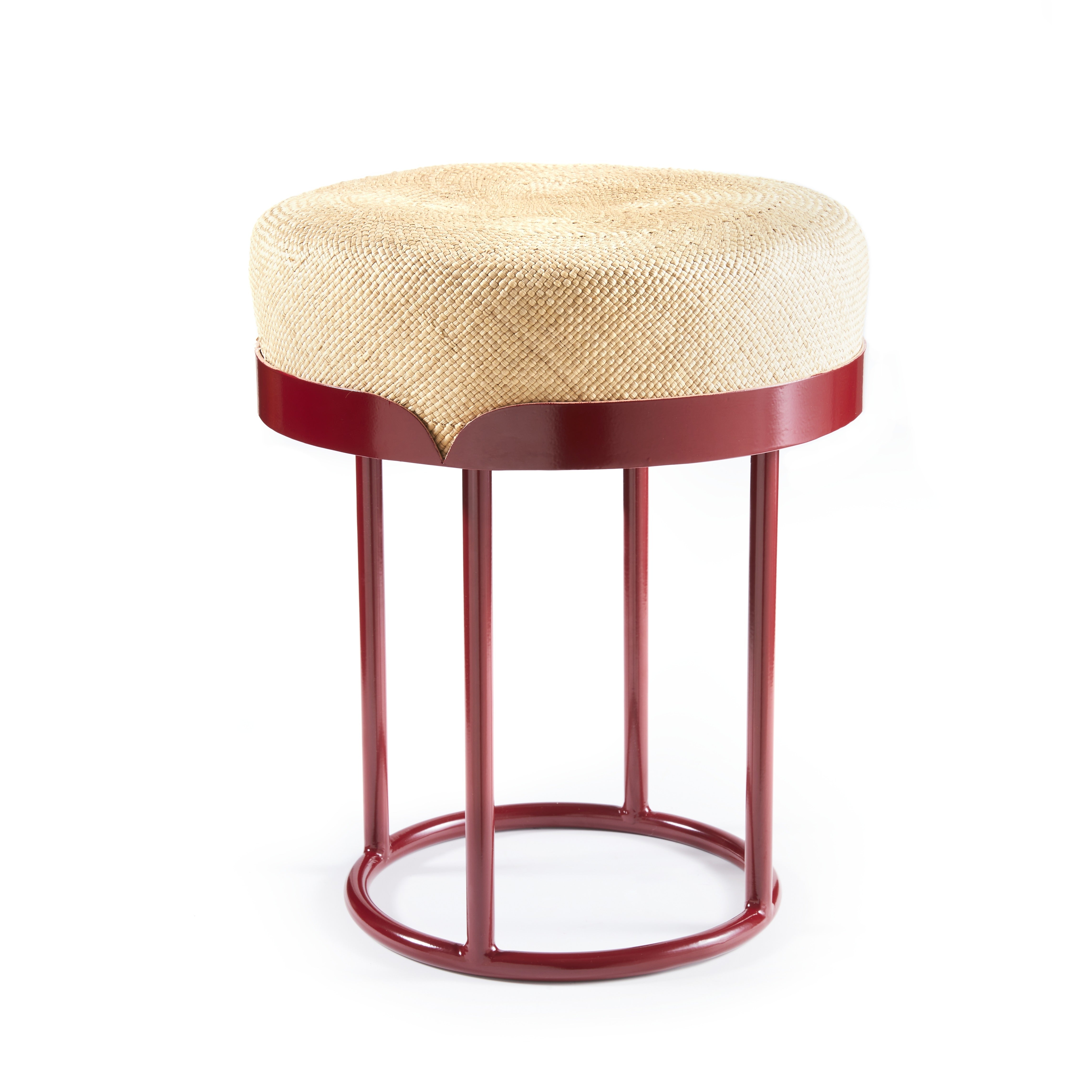 The Ames Victorias Pouf by Ames is a modern stool with a woven beige round cushion and red metal frame, featuring four vertical legs joined by circular supports at the top and base, shown against a white background.