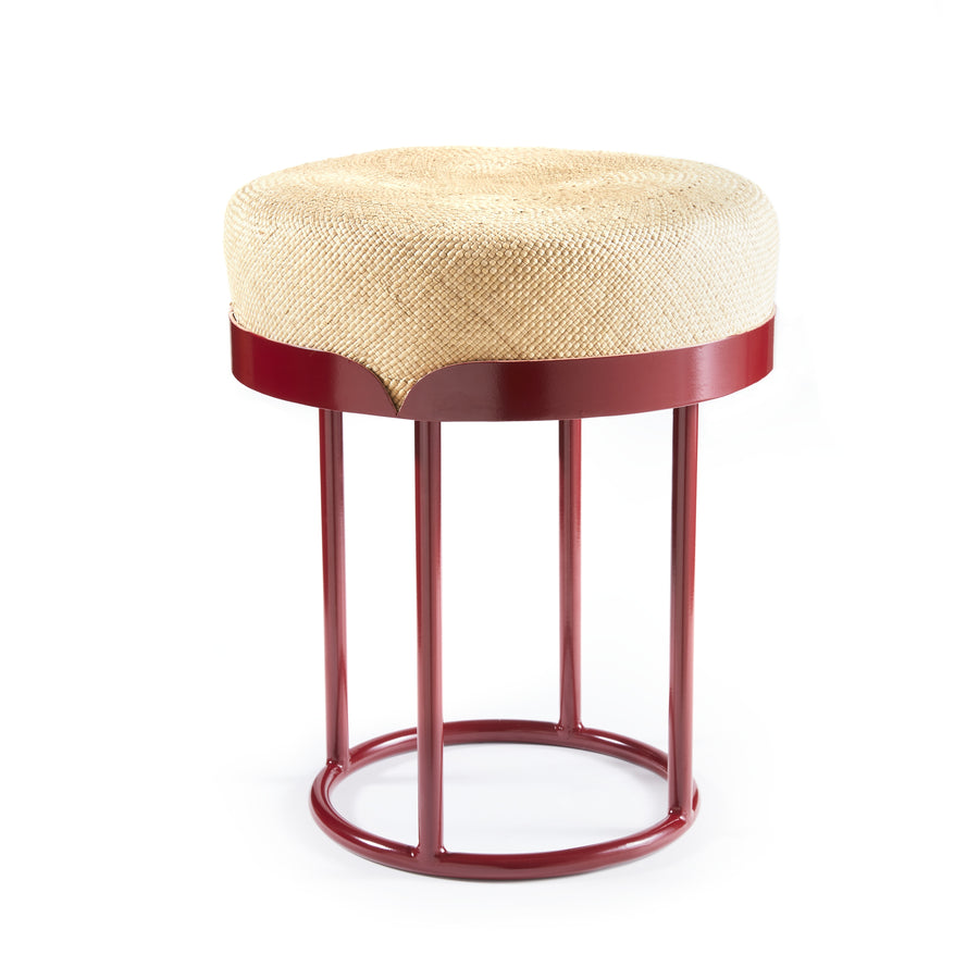 The Ames Victorias Pouf by Ames is a modern stool with a woven beige round cushion and red metal frame, featuring four vertical legs joined by circular supports at the top and base, shown against a white background.