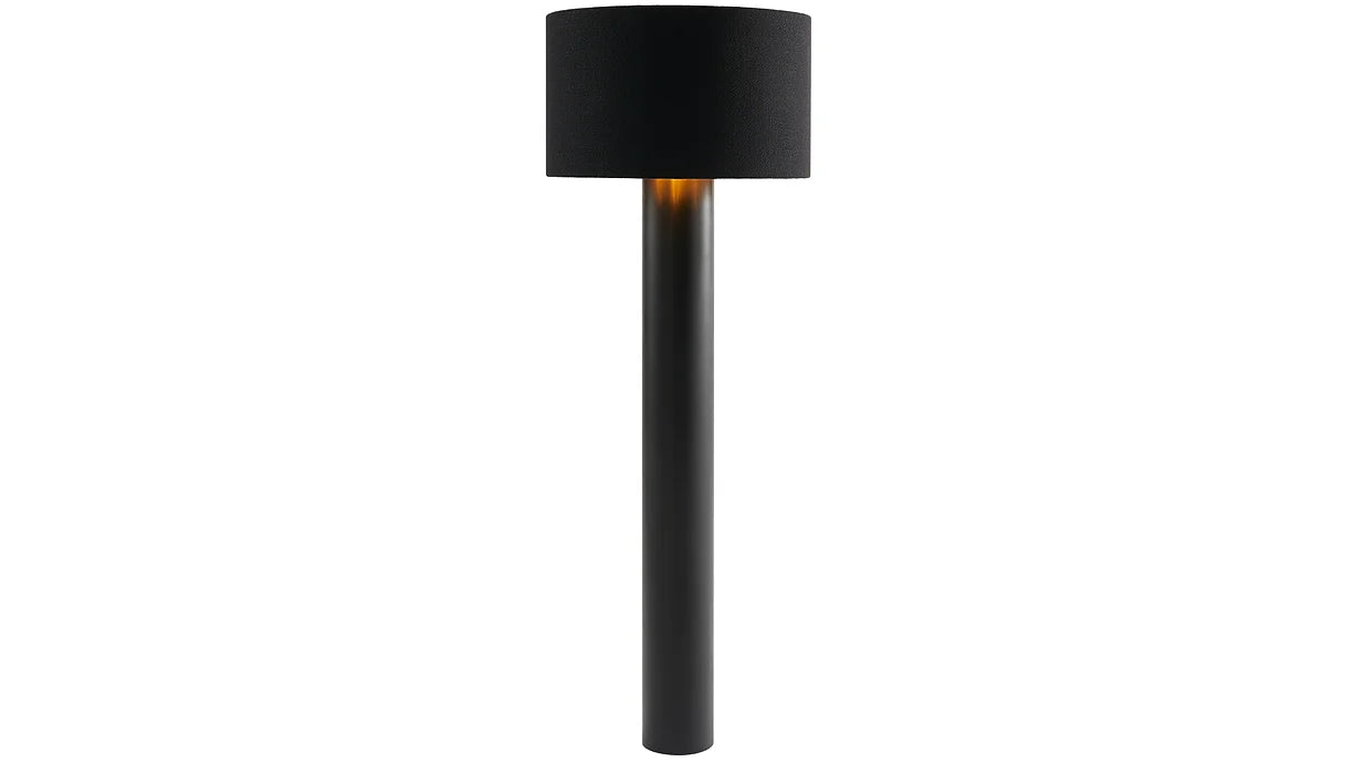 The ALL ROUND Floor Lamp by Victor Foxtrot is a sleek black, minimalist piece with a wool fabric cylindrical base and matching shade. It provides a warm, elegant glow that enhances any space with subtlety.