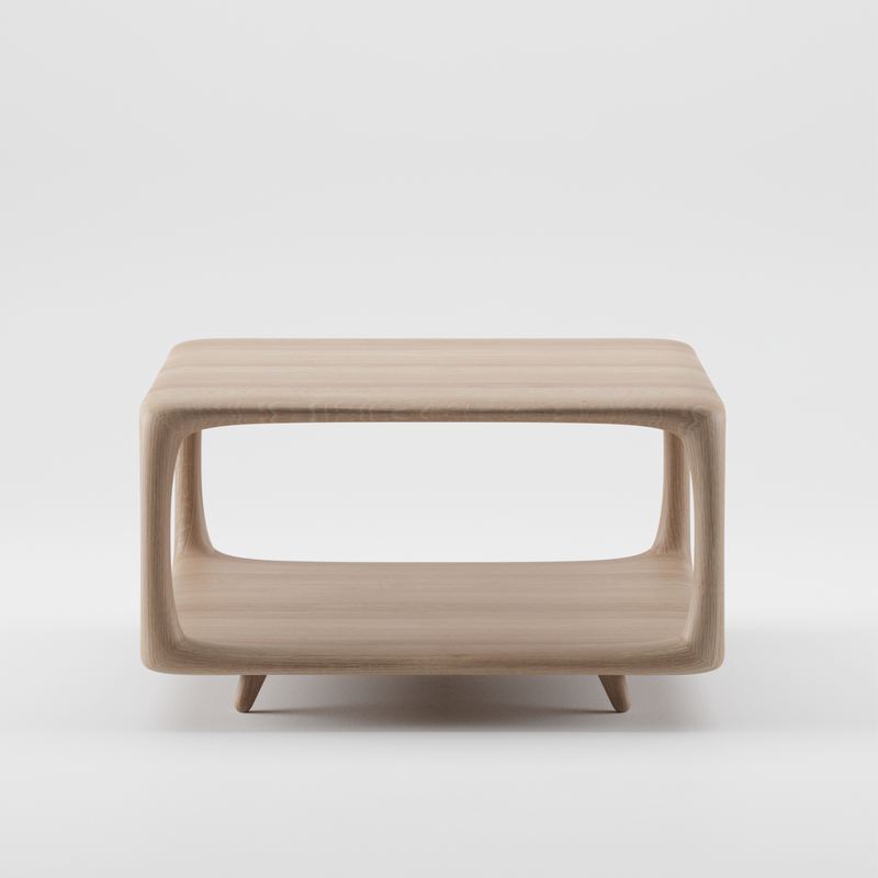 The Artisan BLEND Coffee Table is crafted from solid wood and renewable resources, featuring a modern square shape with open sides and a flat top. Beneath the top lies an integrated shelf, creating a hollow design against a plain white background.