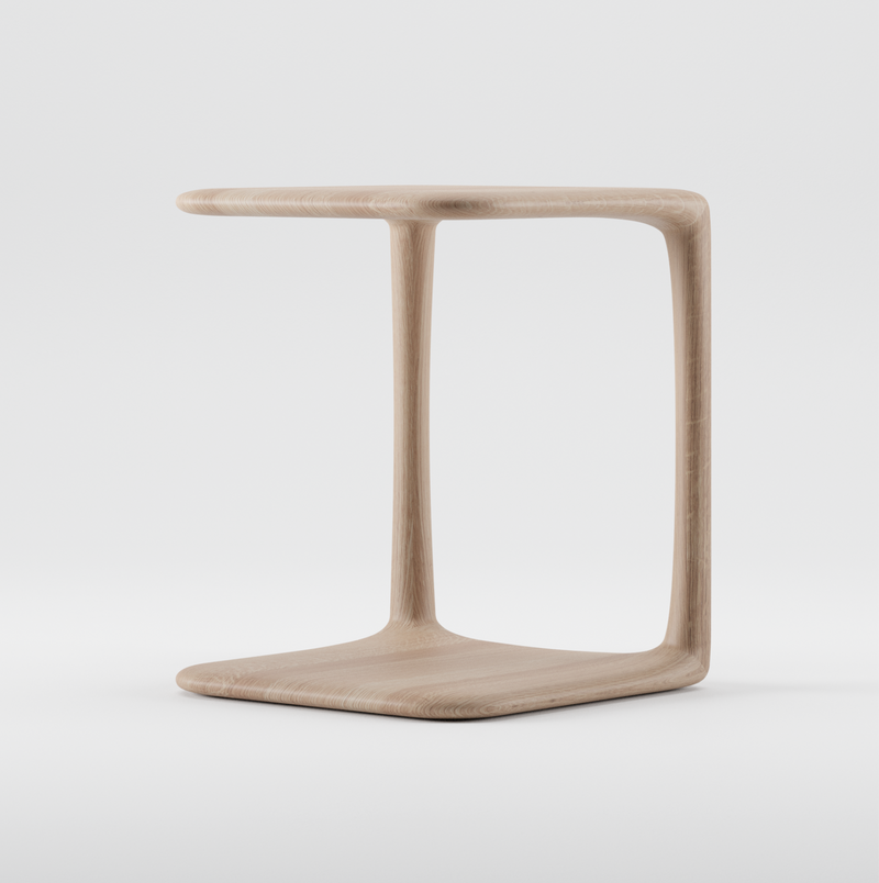 The BLEND Side Table by Artisan is a minimalist, modern C-shaped piece crafted from solid, eco-friendly materials. With a light wood and smooth finish from natural oils, it suits contemporary interiors as an open and airy addition.