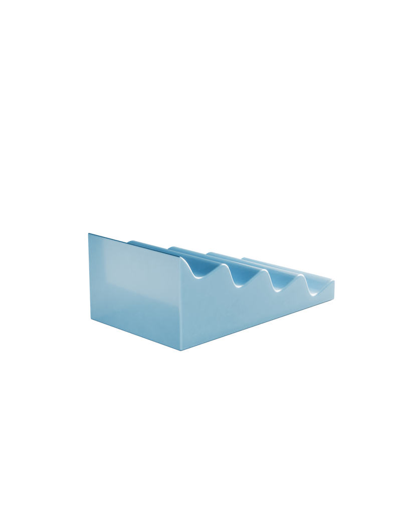 CASCADE Fruitstand in glossy light blue ceramic with curved slots to hold fruits and veggies without bruising.