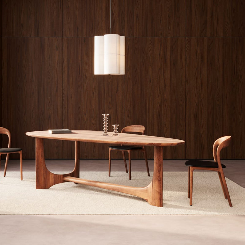 Dining room with wooden table and chairs in a modern interior setting.