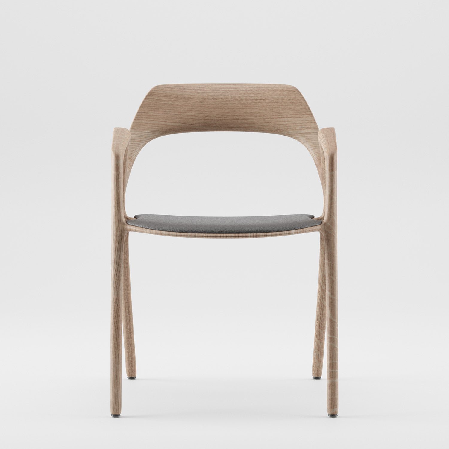 The Ging Chair from Artisan is a modern wooden chair with a minimalist design, featuring a curved backrest and an eco-friendly dark cushioned seat. Photographed against a plain white background, it embodies the ArtisanDesigner Way Object ethos.