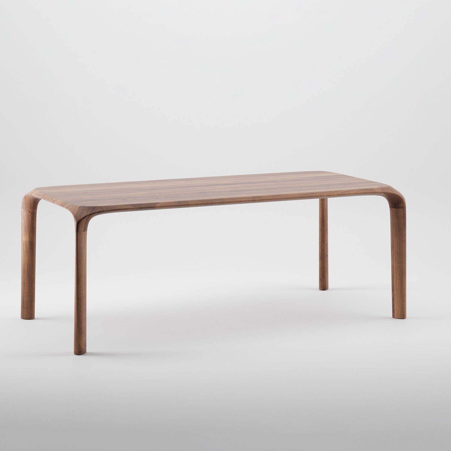 The Ging Table by Artisan is a sleek, minimalist piece crafted from solid wood. With rounded edges and gently curved legs, it highlights the organic beauty of wood. The smooth, polished finish enhances its modern elegance against a plain white background.
