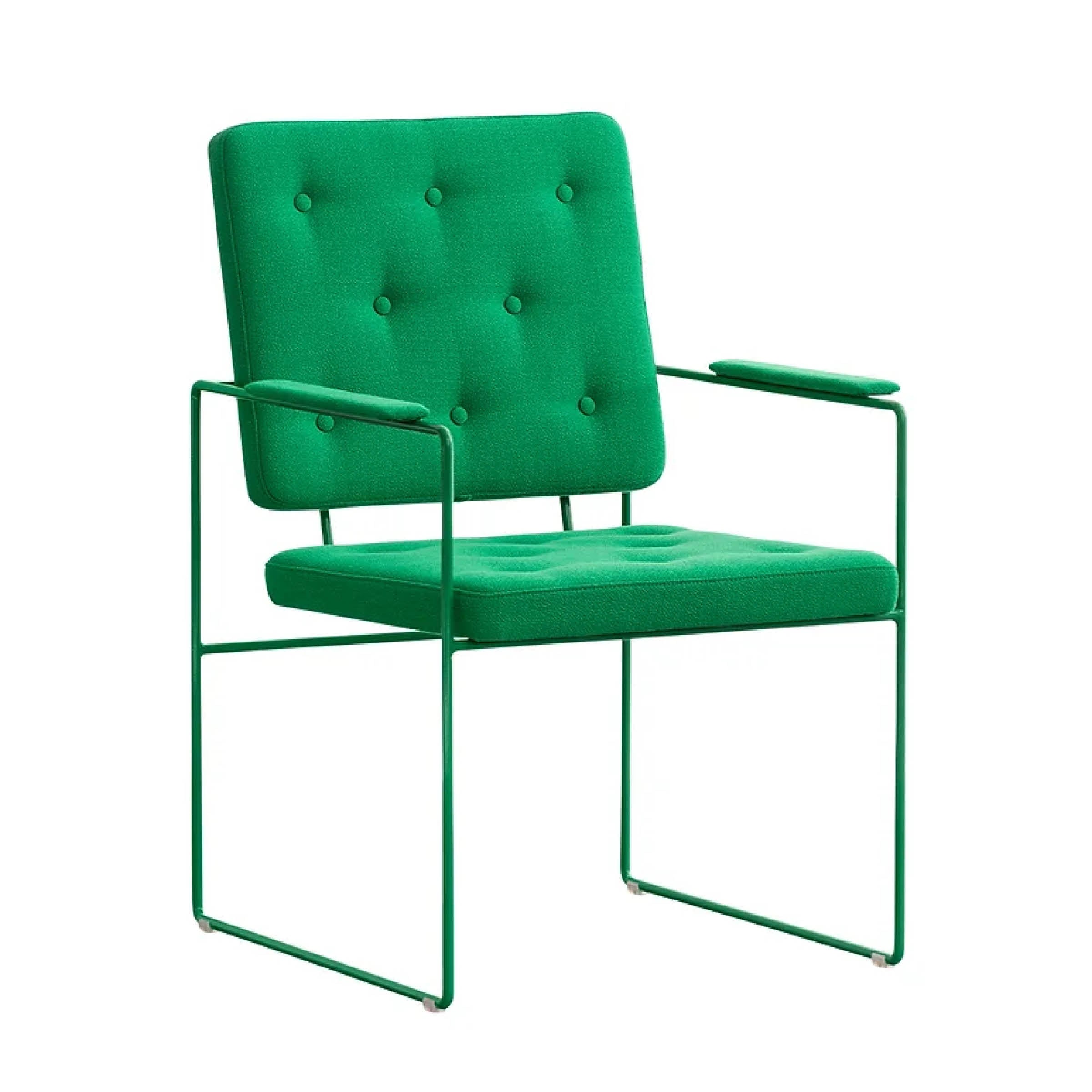 The SWELL TIME Dining Chair by Victor Foxtrot is a modern green chair with a cushioned backrest and seat. It has intricate button stitching, sleek metal armrests, and a minimalist steel frame with thin legs for an elegant contemporary look.