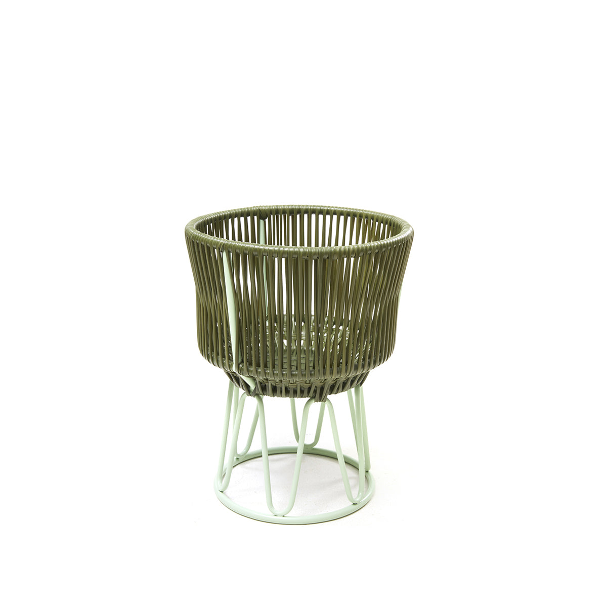 The Ames Circo Flower Pot 1 by Ames features a round, olive-green wicker basket with vertical slats on a light green handcrafted powder-coated steel stand, creating a stylish outdoor piece against a plain white background.
