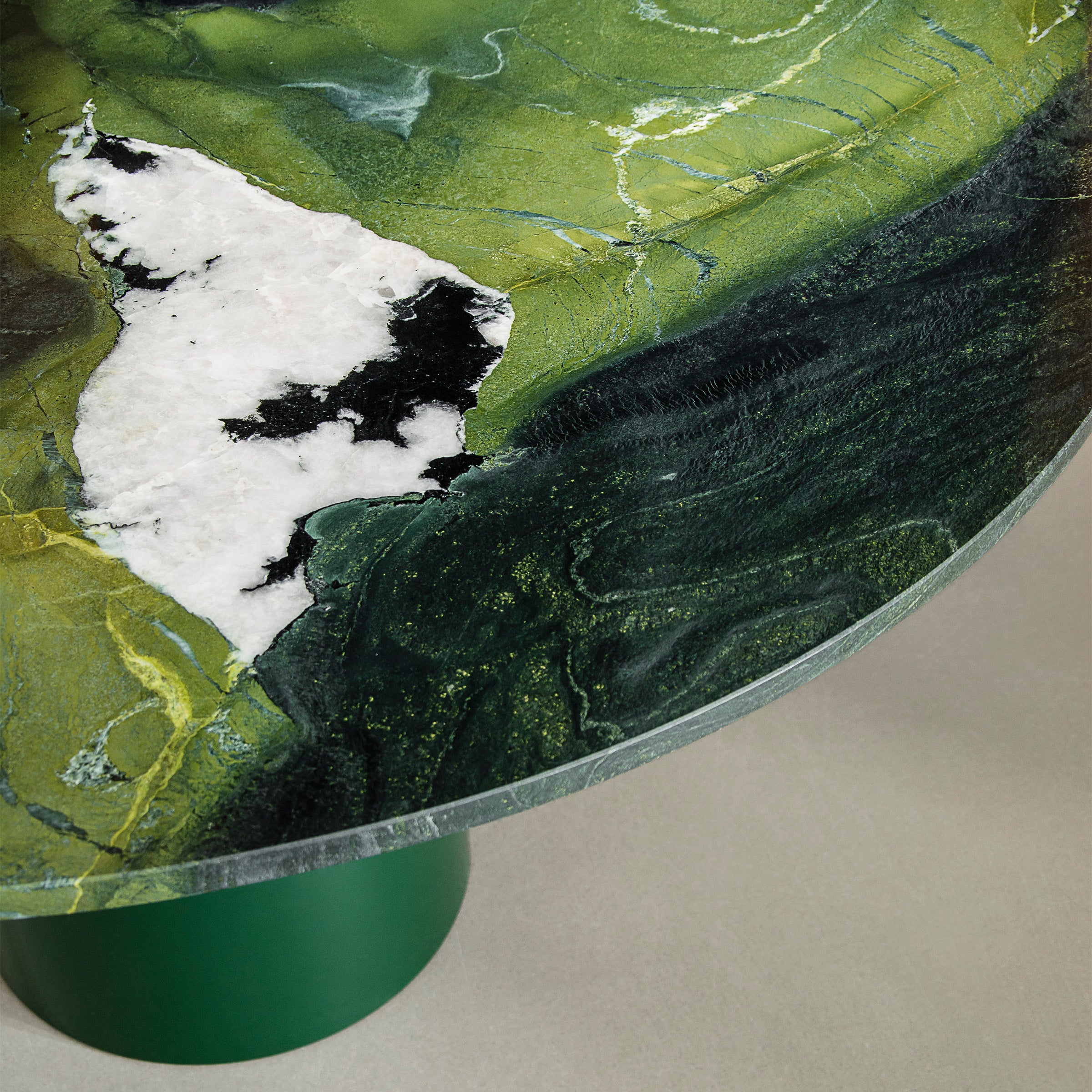 Close-up of the polished green Avocatus quartzite top on the U Turn Table Avocatus with sage base.