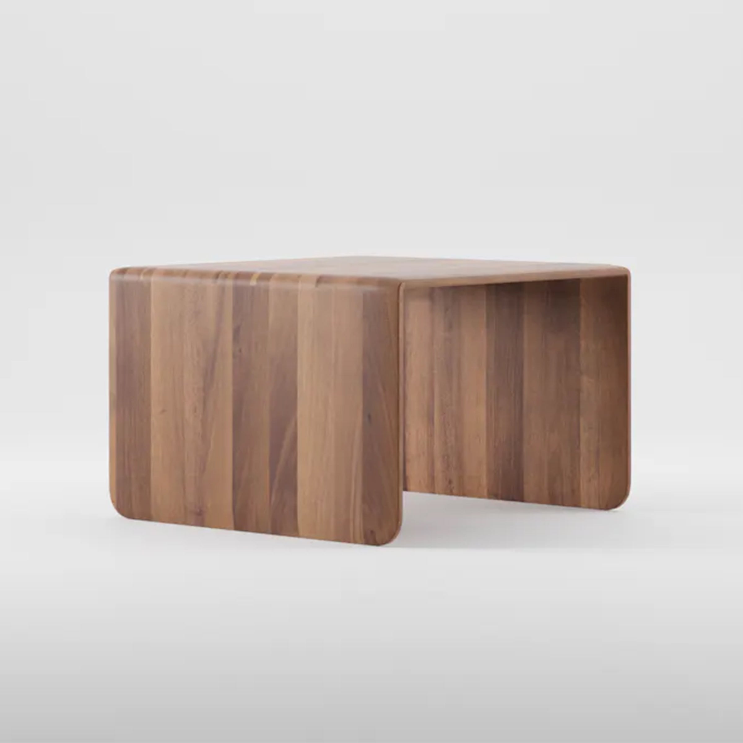 The INVITO Coffee Table by Artisan is a wooden piece with a minimalist design, crafted from solid wood. It has a smooth top, rounded edges, and an arc shape that creates open space below. Its warm, natural finish highlights the woods organic beauty.