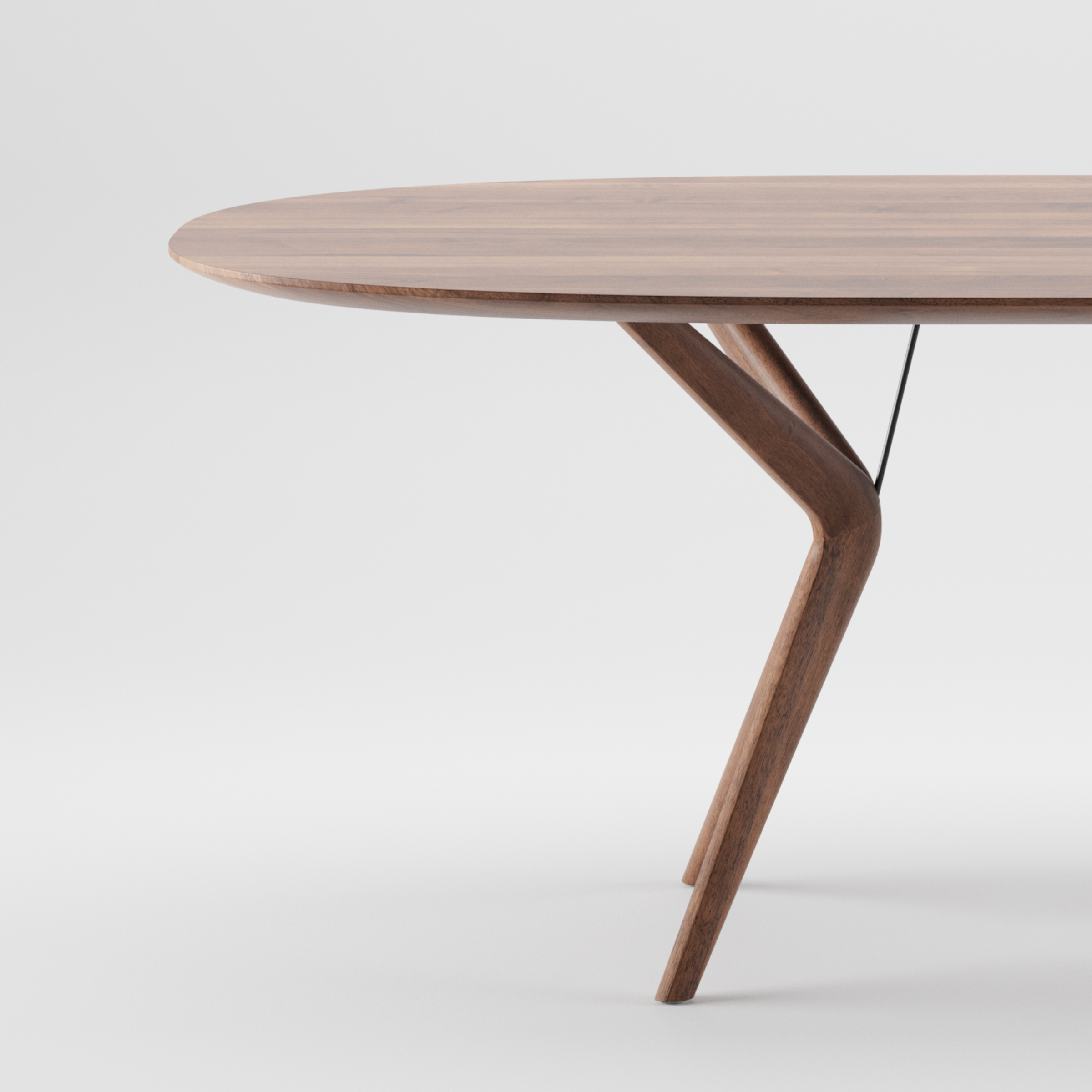 The LAKRI Oval Table by Artisan features a modern wooden design with an oval top and sleek angled legs. Crafted from solid wood with a smooth finish that highlights natural grain, its made with eco-friendly materials. Its minimalist style evokes an elegant contemporary look on a plain white background.