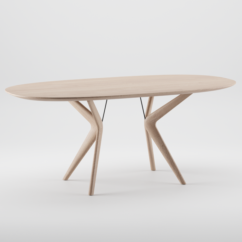 The LAKRI Oval Table by Artisan is modern with a luxurious wood texture and light finish. Its uniquely angled legs converge in the center, creating a striking visual against a plain white background. Made from eco-friendly materials, its both stylish and sustainable.