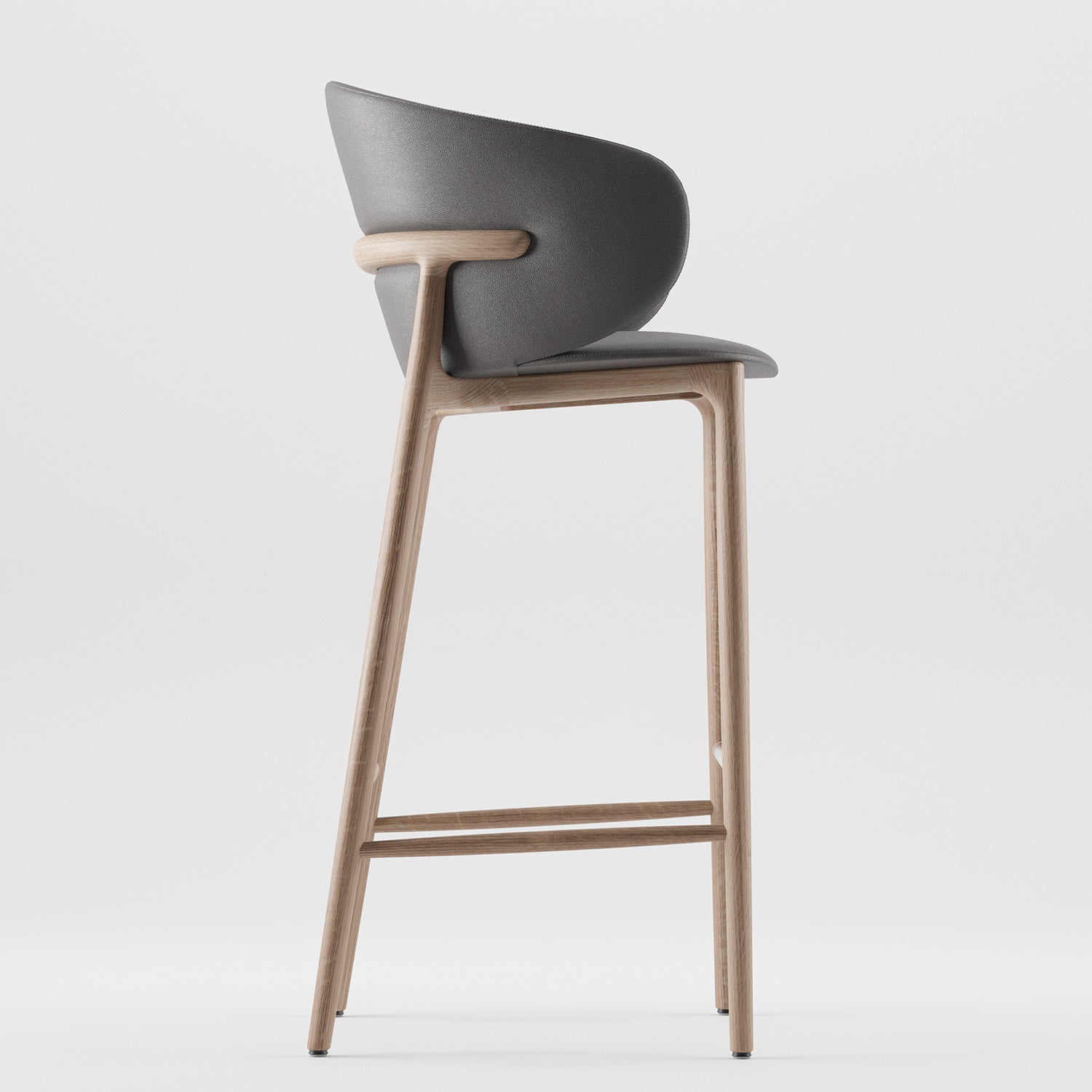 The Mela Bar Chair by Artisan boasts a modern, mid-century inspired design featuring a sleek gray seat and backrest, an upholstered shell, and a light wooden frame with a footrest for a minimalist aesthetic.