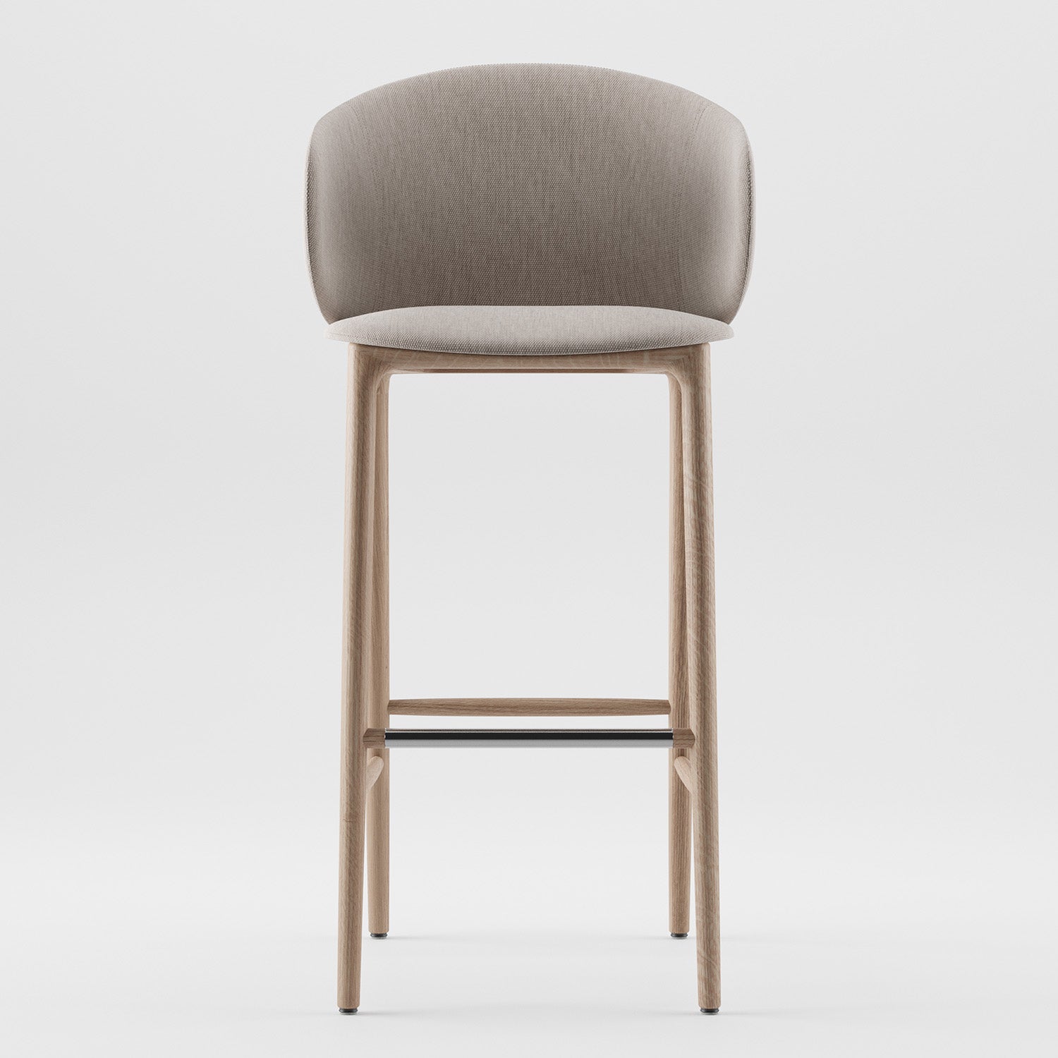 The Artisan Mela Bar Chair is a modern stool with a beige upholstered shell and curved backrest. It showcases mid-century inspiration with light wood legs and a sleek black metal footrest, all against a plain white backdrop.