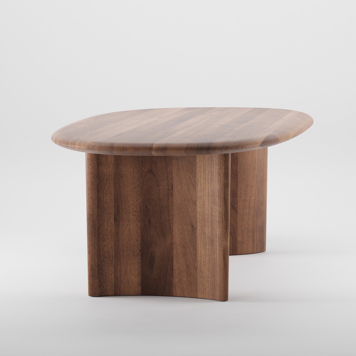 The Artisan MONUMENT Table features a smooth, oval top and sturdy, curved solid wood legs. The rich grain is polished with natural oils for an elegant look, set against a plain, light background.