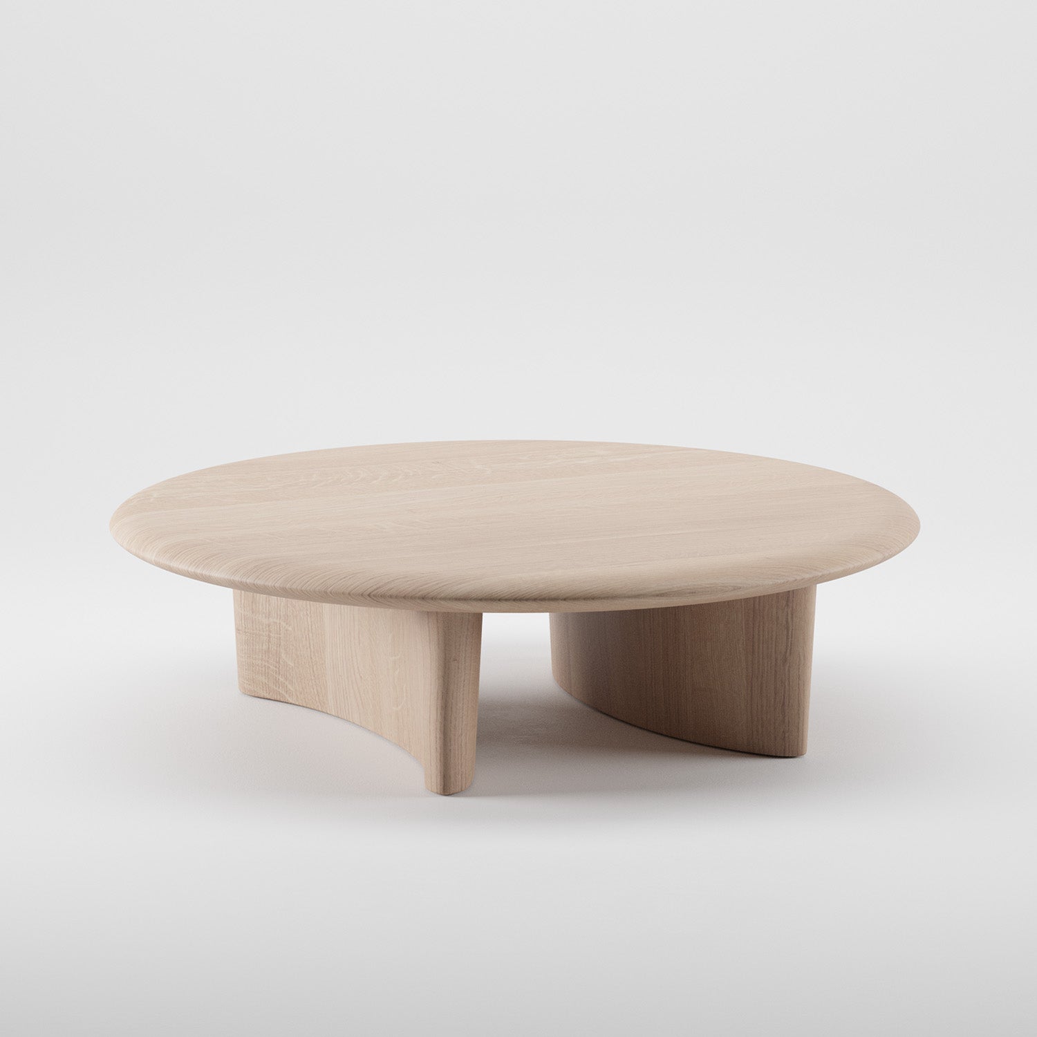 The MONUMENT Round Coffeetable by Artisan is a minimalist piece with a light wood finish. Made from eco-friendly materials, it boasts a simple modern design with a solid top and three curved supports, combining functionality and contemporary style against a plain white background.