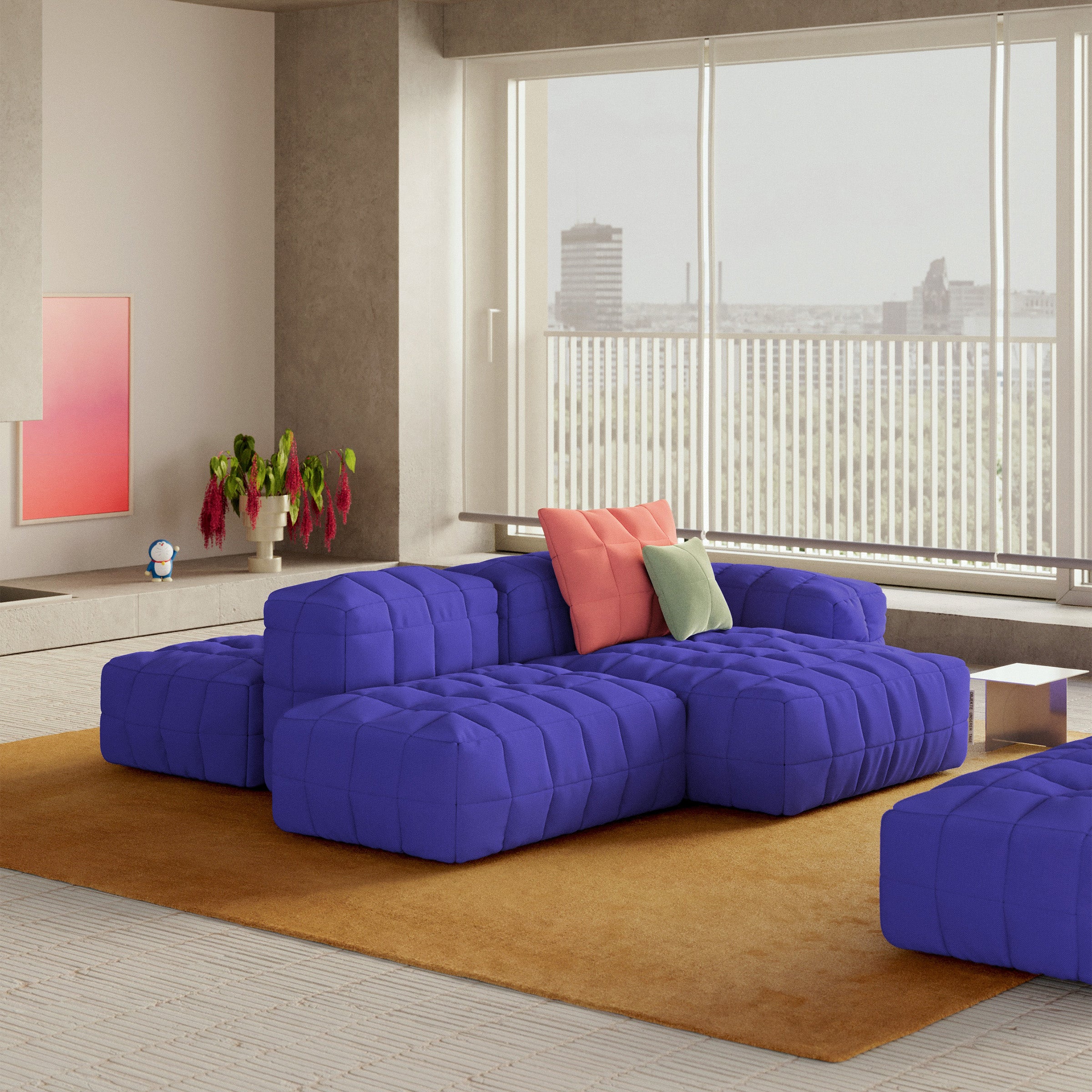 Henn Sofa in modular design with padded cushions and colorful pillows in a modern living room setting.