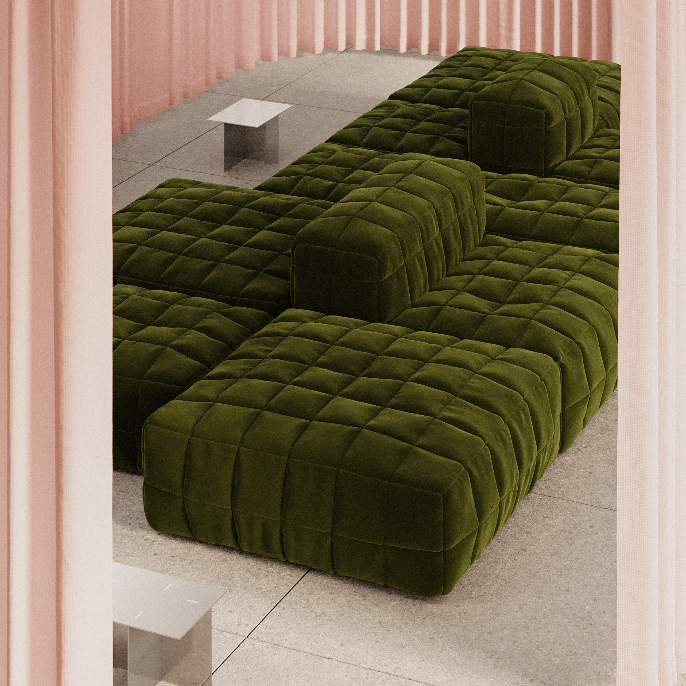 Henn Sofa in dark green with quilted cushion covers forming modular shapes in a modern room setting.