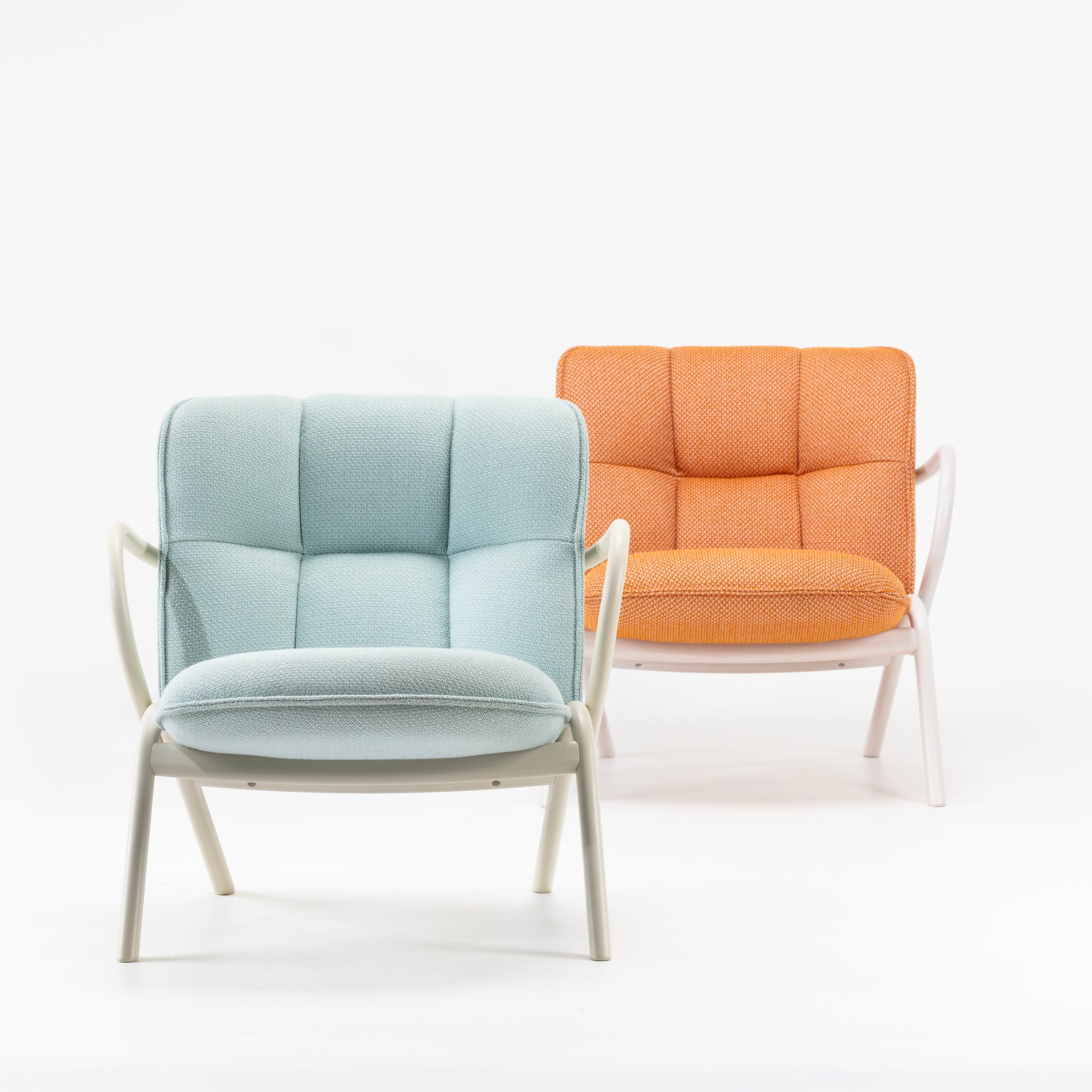 Two cushioned Cissy Lounge Chair Low-Back seats with bentwood frames in pastel blue and orange colors.
