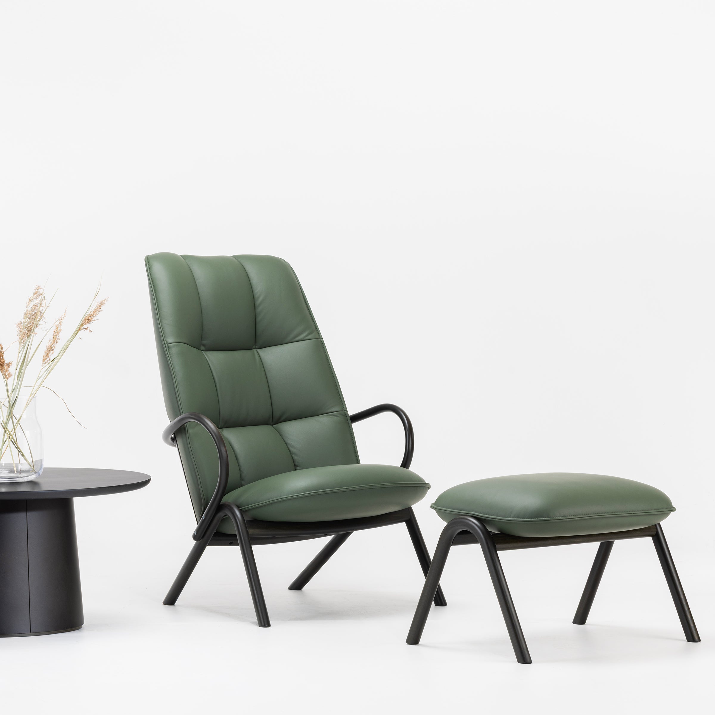 Cissy Lounge Chair High-Back in green upholstery with bentwood frame and matching footstool on white background