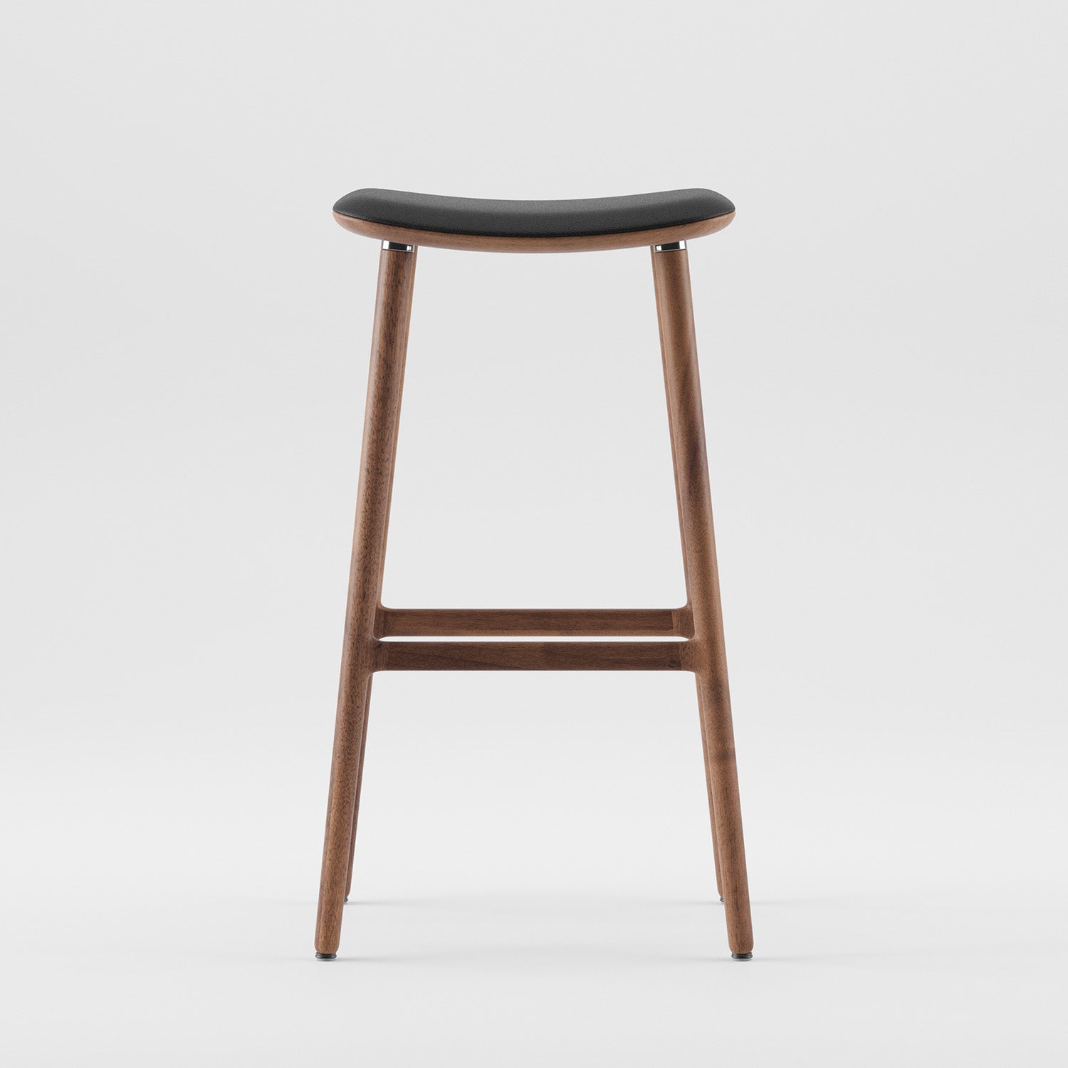 The Artisan NARU Barstool features a tall wooden frame with a luxurious texture and curved black seat. It boasts sleek legs and a horizontal support bar, crafted from eco-friendly materials. Set against a white background, it highlights its minimalist design.