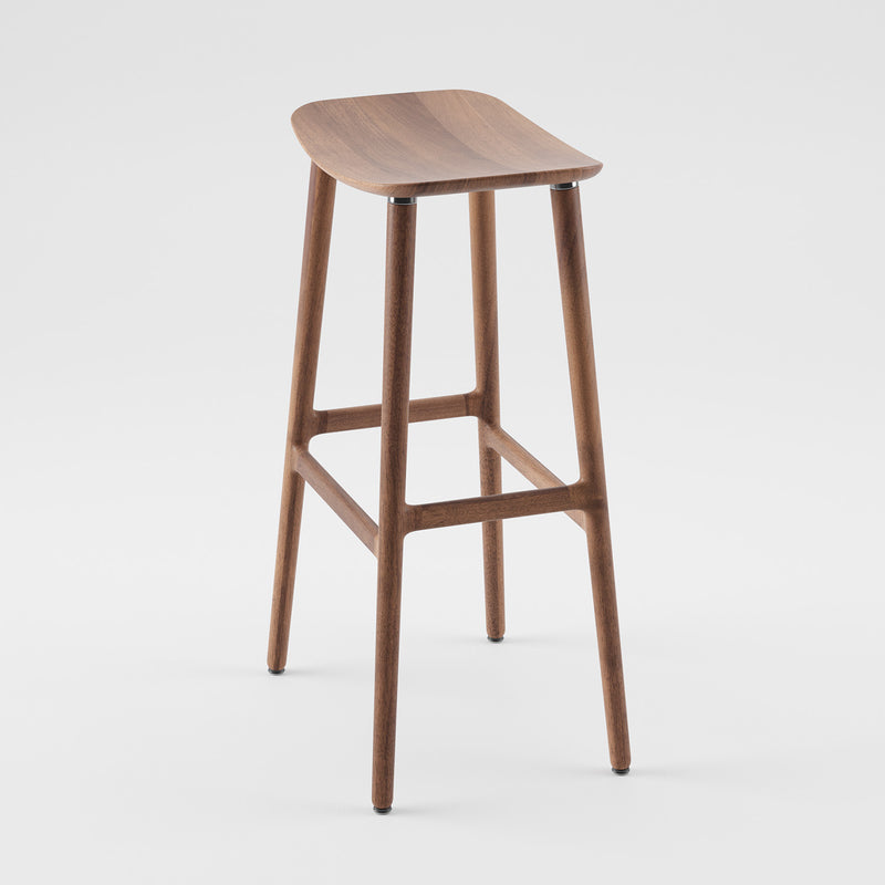 The Artisan NARU Barstool showcases a sleek, minimalist design with four slender legs, a curved seat, and a simple footrest. Made from solid wood, its eco-friendly and features a polished finish that highlights the natural color and luxurious texture.