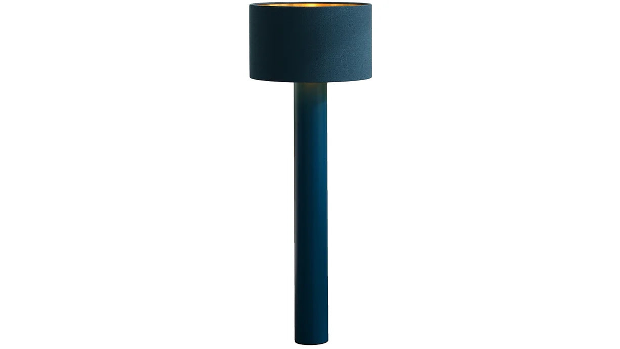 The ALL ROUND Floor Lamp by Victor Foxtrot features a tall, cylindrical dark blue base and matching wool shade. Its interior emits a warm golden glow, standing elegantly against a plain white background.