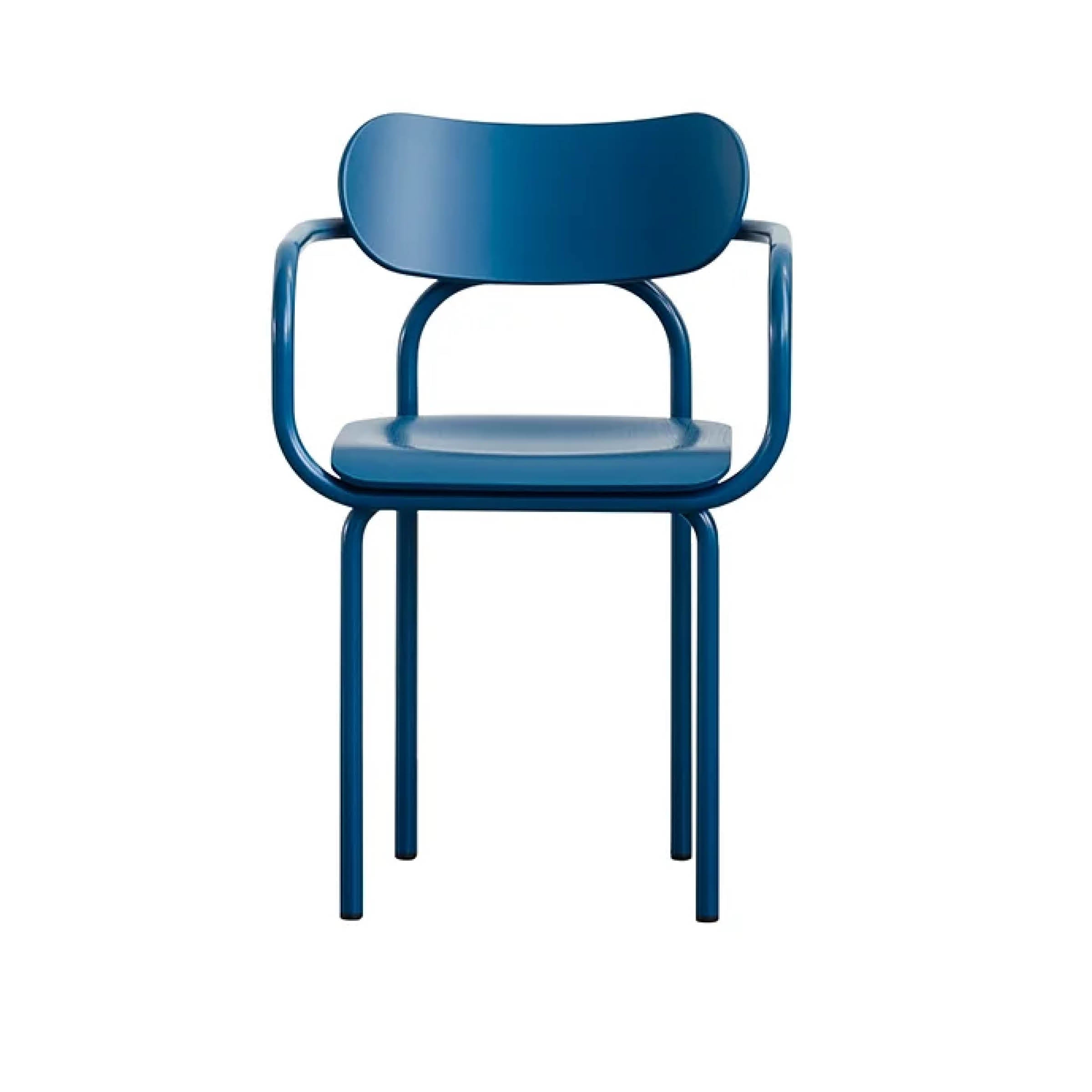 The Double U Armchair by Victor Foxtrot features a modern blue design with a curved seat, backrest, rounded armrests, and four straight tubular steel legs. Its iconic minimalist aesthetics stand out against a plain white background.