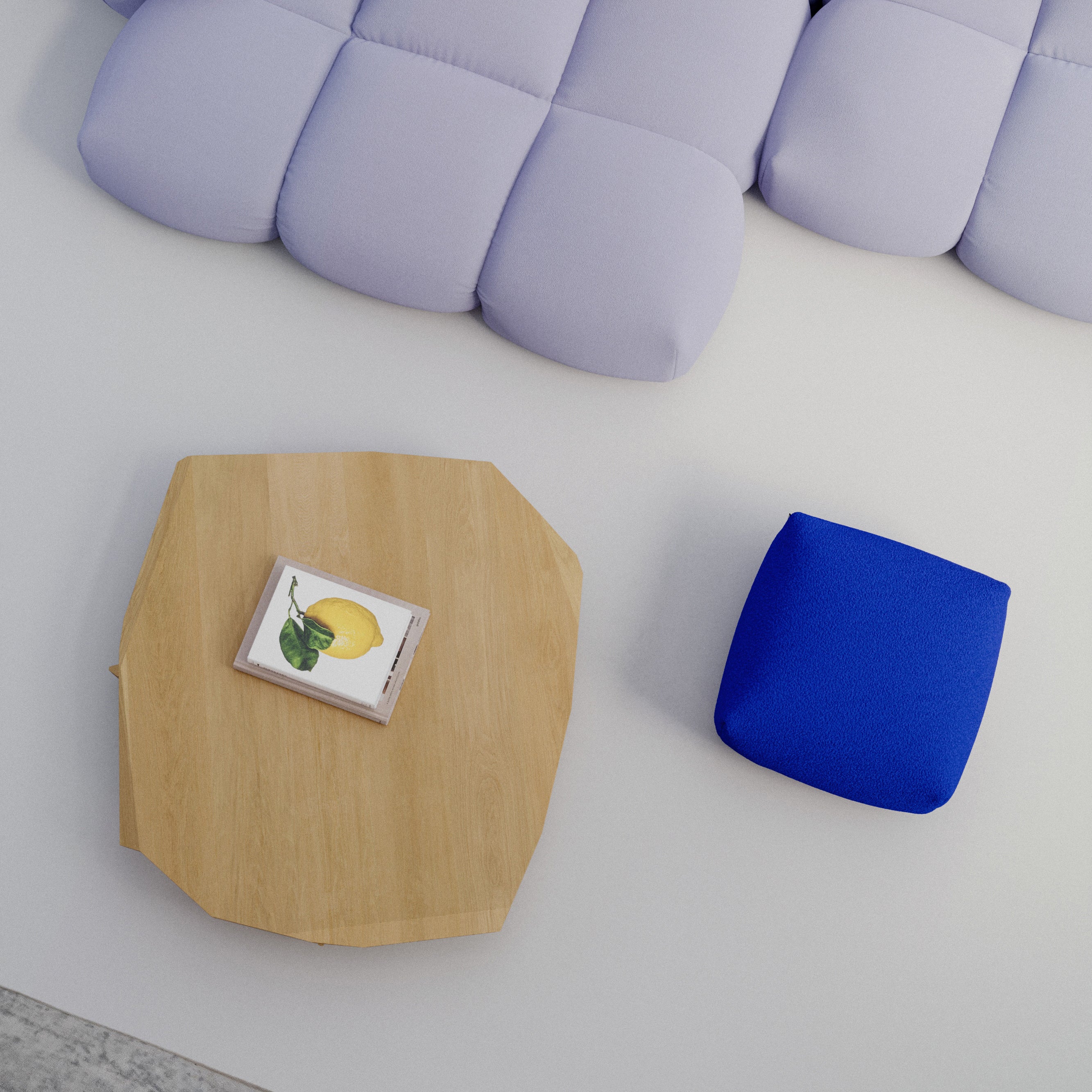 In a modern setting, the Objekte unserer Tage Fels Coffee Table features a sculptural geometric design in light wood, paired with a lemon-accented book and bright blue cushion. Above is a light blue tufted sofa with curved sections on a light gray floor, showcasing exquisite craftsmanship.