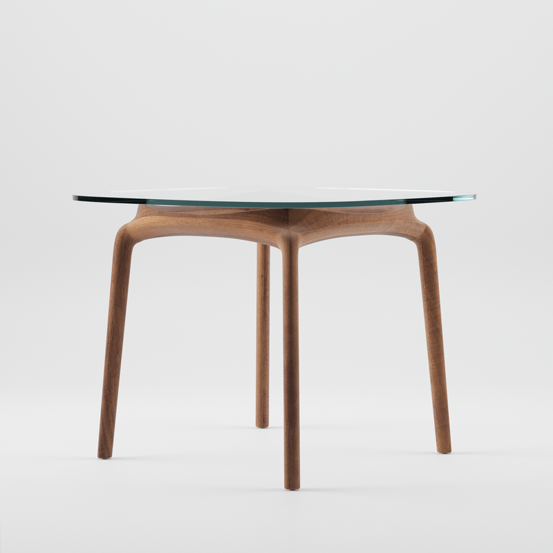 The Artisan PASCAL Square Table showcases a minimalist design with a solid wooden base and sleek, tapering legs that support a clear glass top. Enhanced by natural oils to highlight the wood grain, it stands against a plain white background, exuding an eco-friendly charm.