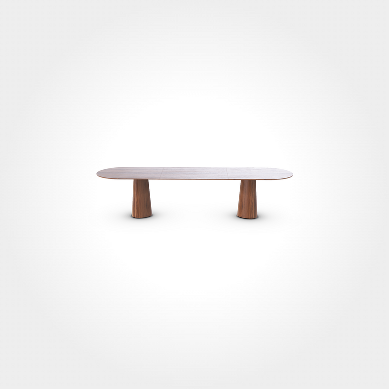 The P.O.V. Plus Table 480 by TON is a sleek, modern piece with a rectangular wooden top, rounded corners, and two cylindrical wooden legs at each end. Its minimalist design against a plain white background makes it ideal for both hospitality dining and stylish home interiors.