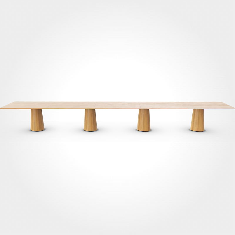 The P.O.V. Plus Table 481 by TON is a minimalist wooden dining table with a smooth finish and four cylindrical legs, adaptable for both office and dining use. It has a long, rectangular design set against a plain white background.
