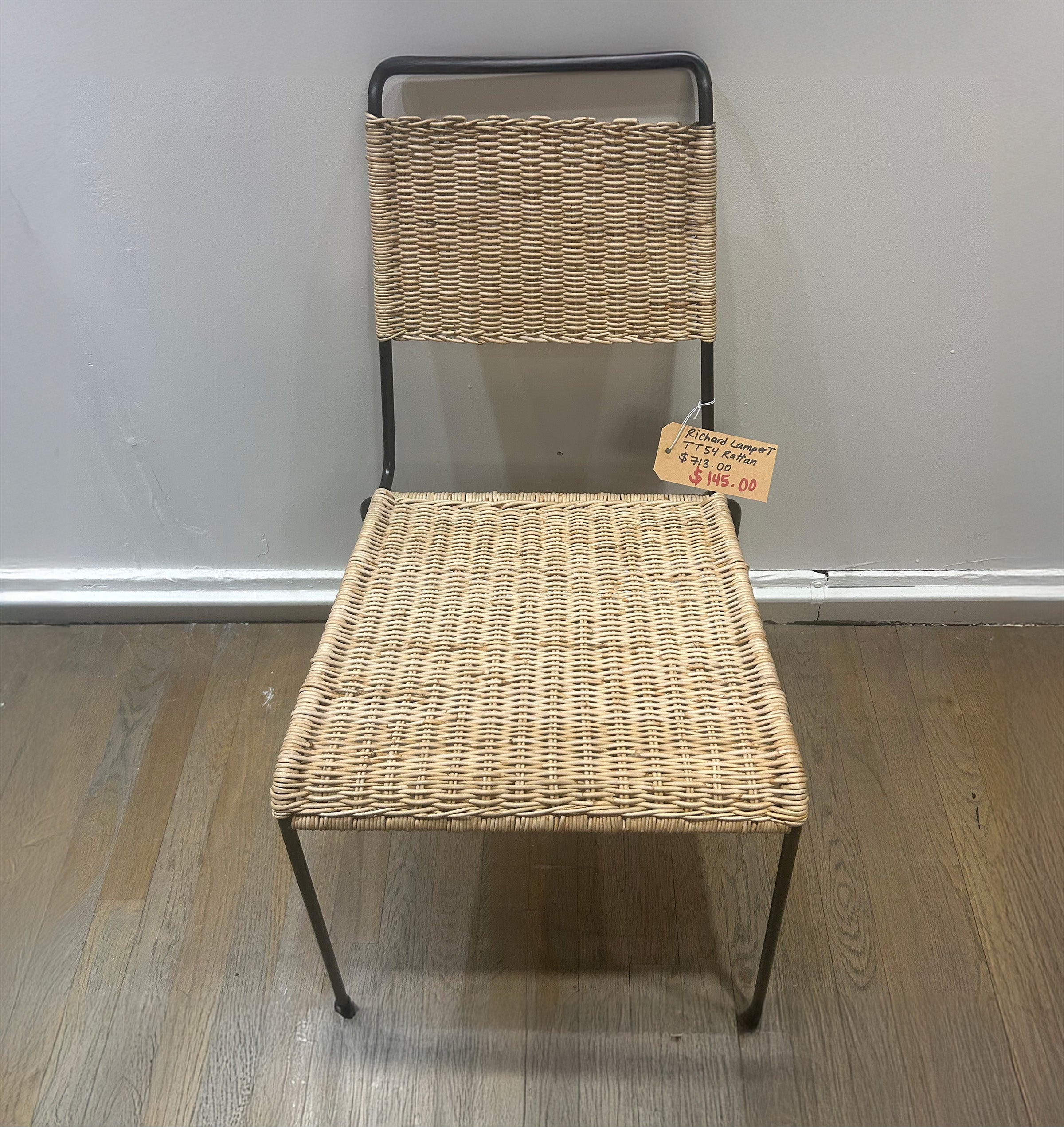 TT54 Rattan - Sale showing a rattan seat and backrest with black steel rod frame chair on wooden floor.