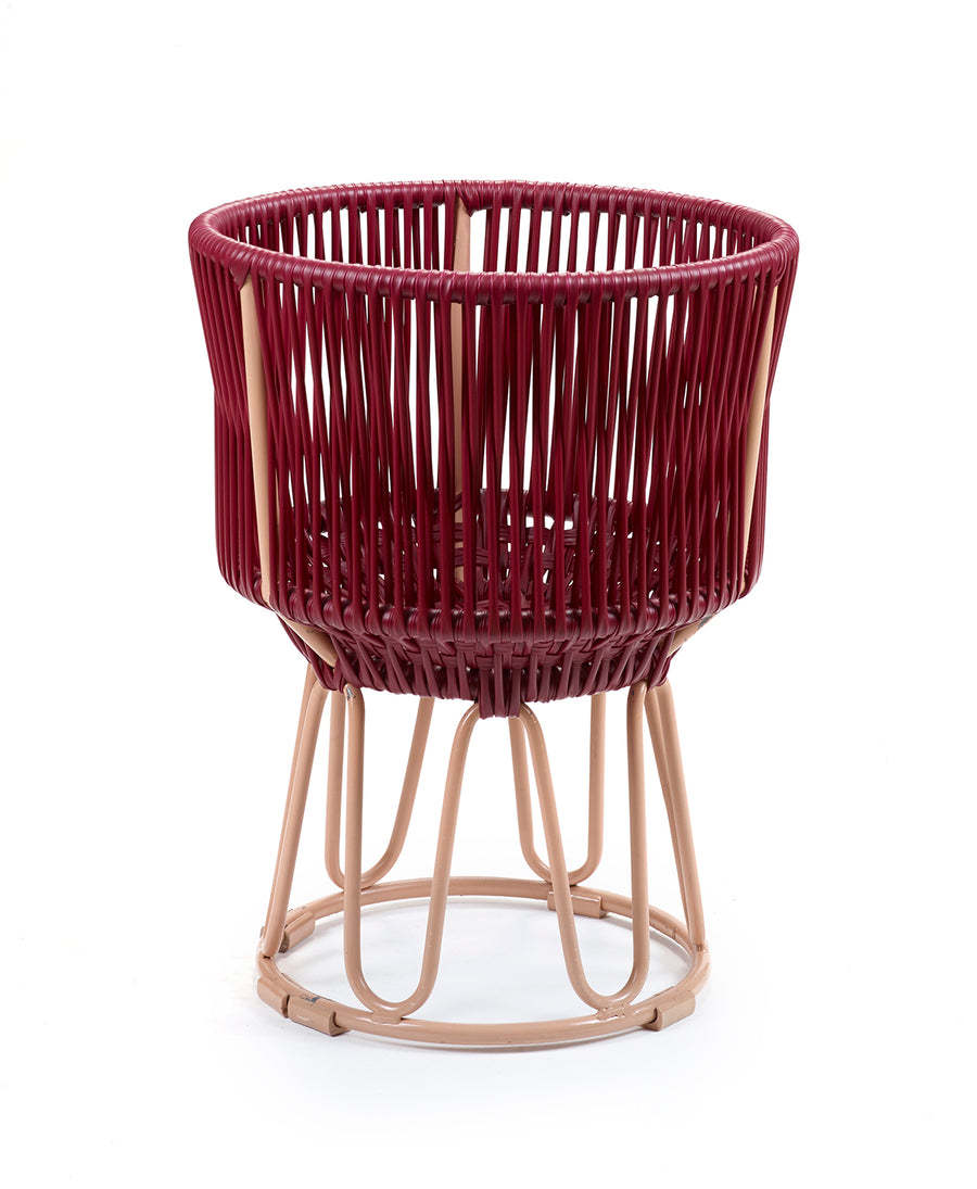 The Ames Circo Flower Pot 1 by Ames features a round maroon synthetic weave seat and light beige handcrafted powder-coated steel legs in an open, airy design, shown against a white background.