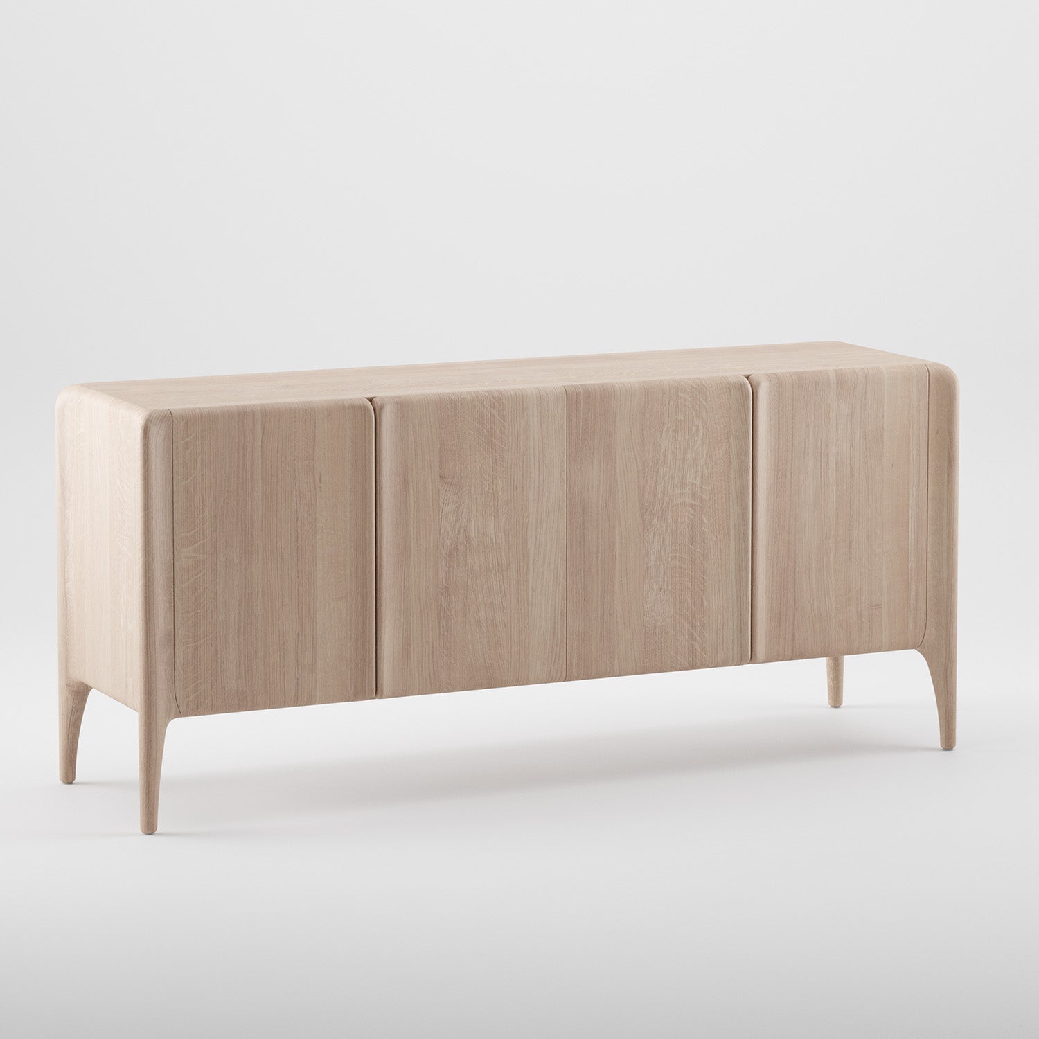 The Artisan RIO Sideboard is a minimalist piece made from solid wood, featuring three convex doors, a smooth surface, and rounded edges. It stands on four slightly tapered legs with a light, natural finish using eco-friendly materials for a modern and elegant look against a plain white background.