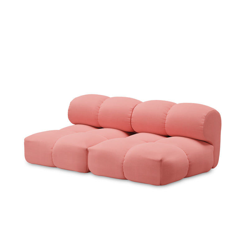 The Sander Sofa by Objekte unserer Tage is a modern three-seater in pink with ultrasoft upholstery and a minimalist design, featuring rounded tufted cushions and a low-profile structure, bringing a cozy yet contemporary feel against a plain white background.