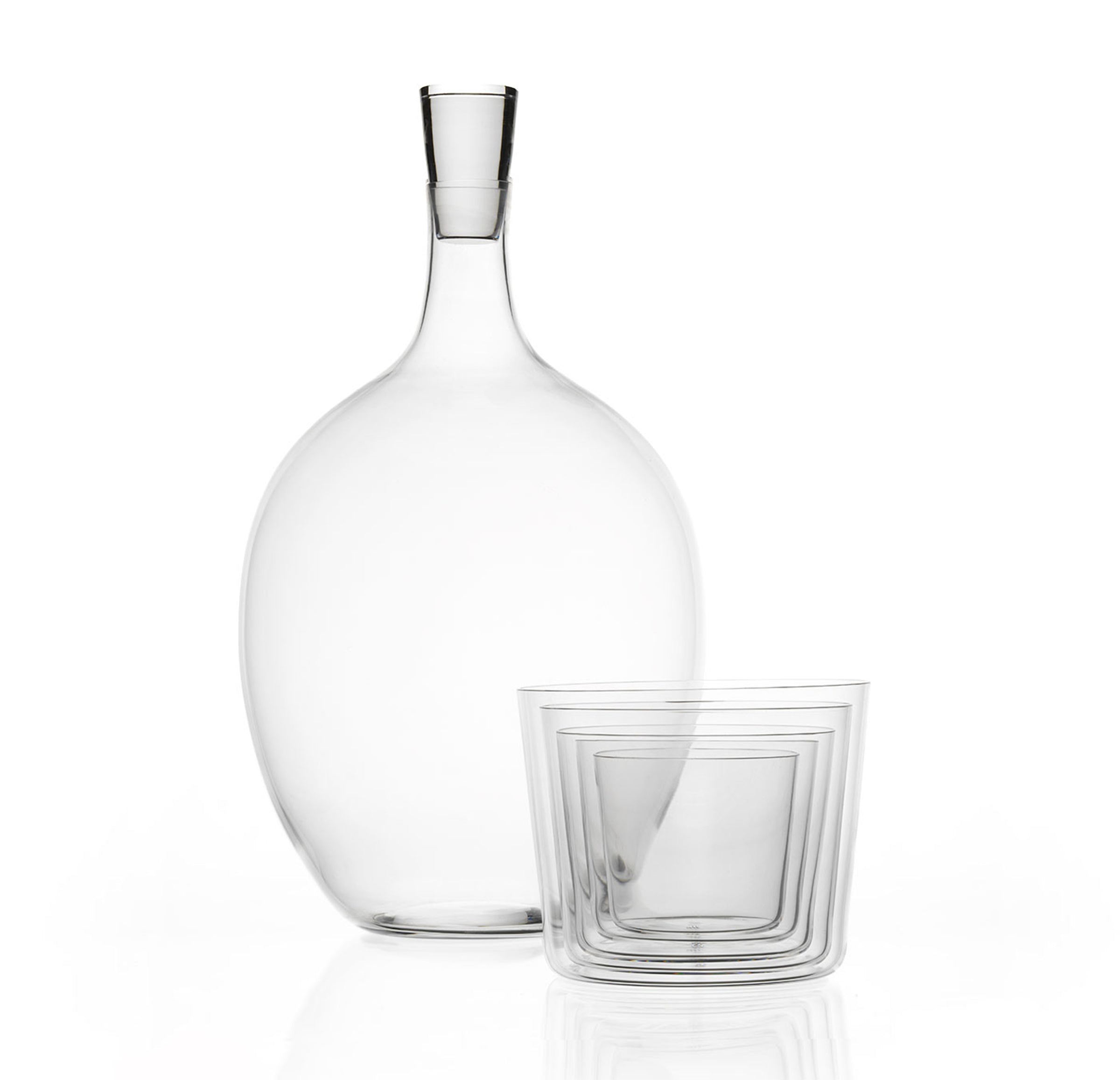A clear, elegantly designed carafe with a slim neck is paired with a matching transparent tumbler, crafted from mouth-blown lead-free crystal. The modern Lobmeyr Drinking Set No. 1003 stands against a plain white background, highlighting its sleek aesthetics.