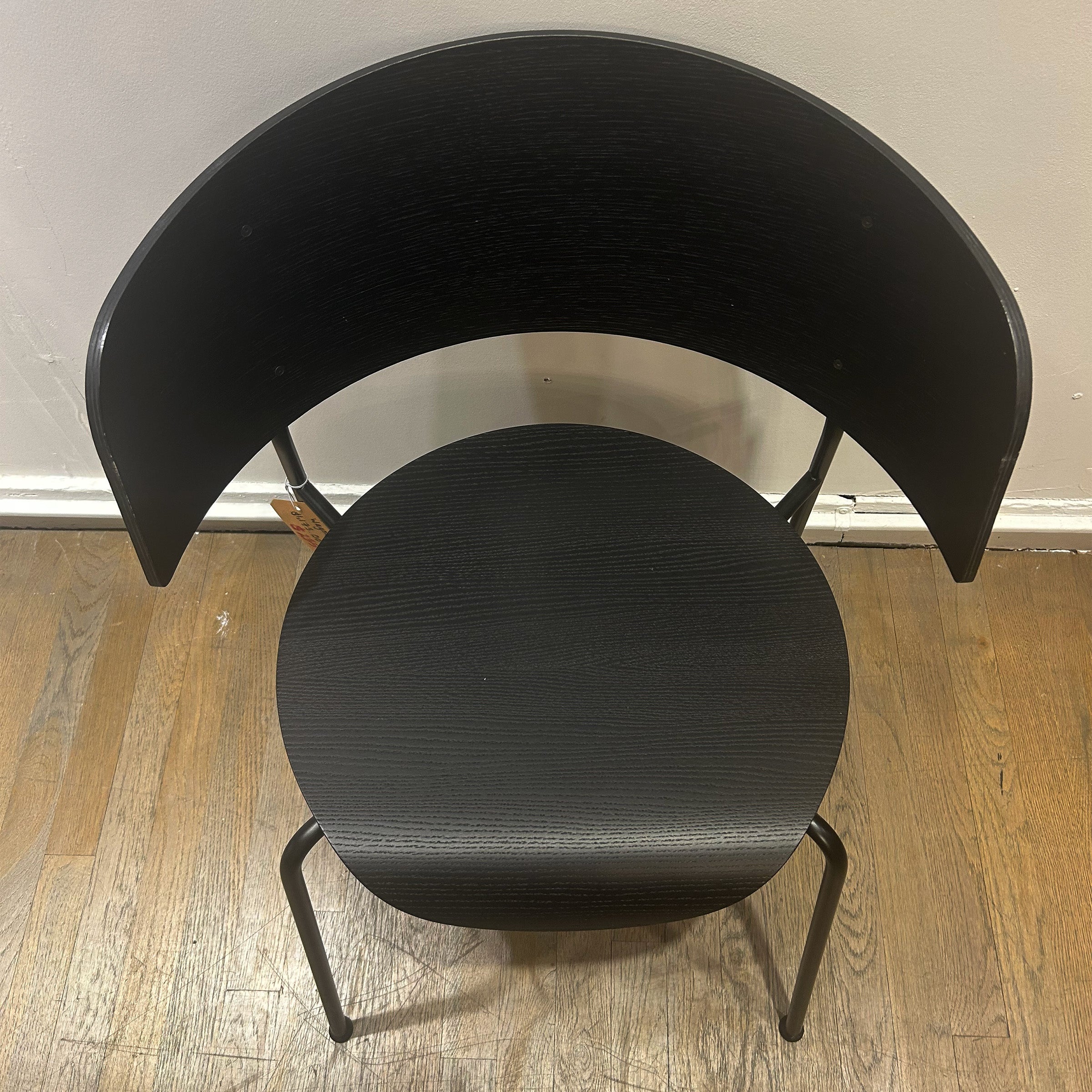 Wagner Dining Chair - Sale, black wood curved backrest and seat with metal legs on wooden floor.