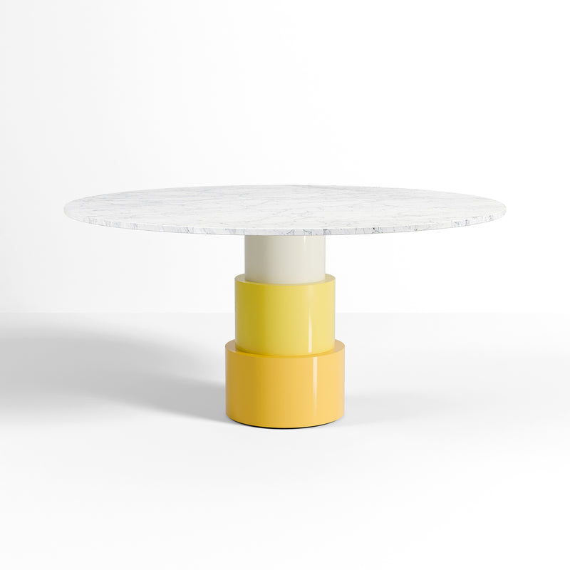 U Turn Table Carrara Marble with round white marble top and yellow powder-coated steel tapered base.