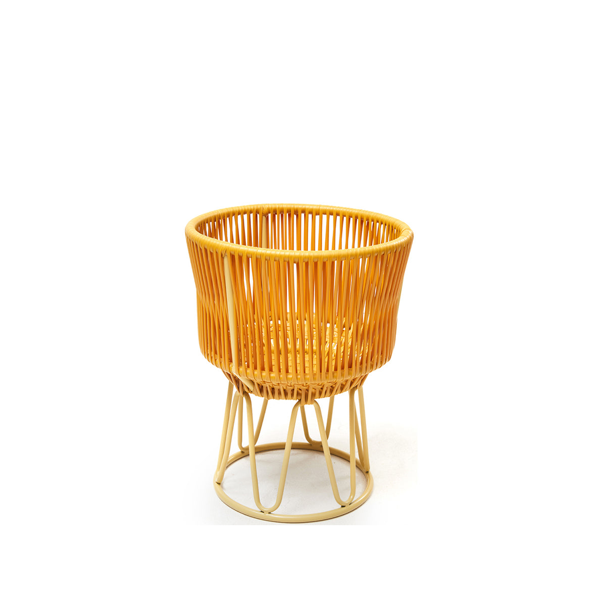The Ames Circo Flower Pot 1 by Ames is a round, yellow rattan-inspired pot with an open, woven design and four handcrafted powder-coated steel legs joined by a circular base, perfect as a stylish outdoor accent.